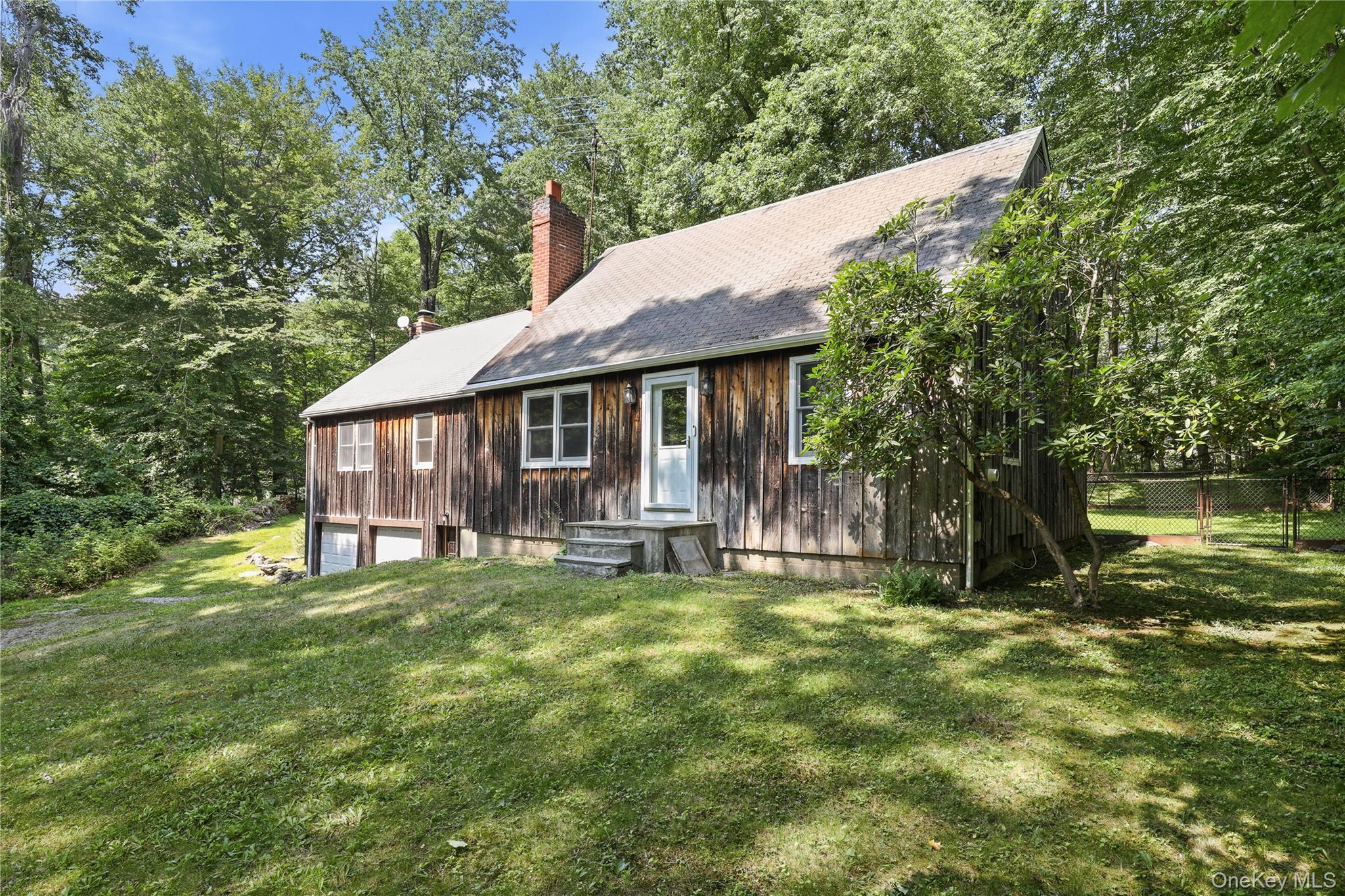 This lake community home has deeded access to Truesdale Lake and is located in the award-winning Katonah-Lewisboro School District.  Located on a quiet cul-de-sac, this expanded cape cod-style home has good bones and great potential.  Upon entering, a fireplace warms the front parlor and living room.  Beyond, the kitchen opens to a dining room and an expanded family room with a stone fireplace, home office/den, and a large outdoor deck, forming the hub of this four-bedroom home.  There are two bedrooms upstairs and two down, with a full bathroom on each floor.  Extra storage is available in an attic easily accessible from the second floor as well as in a large unfinished basement.  The level backyard includes a fenced area, old stone walls, mature trees, a concrete pad/patio with a basketball hoop, and plenty of room for a garden.