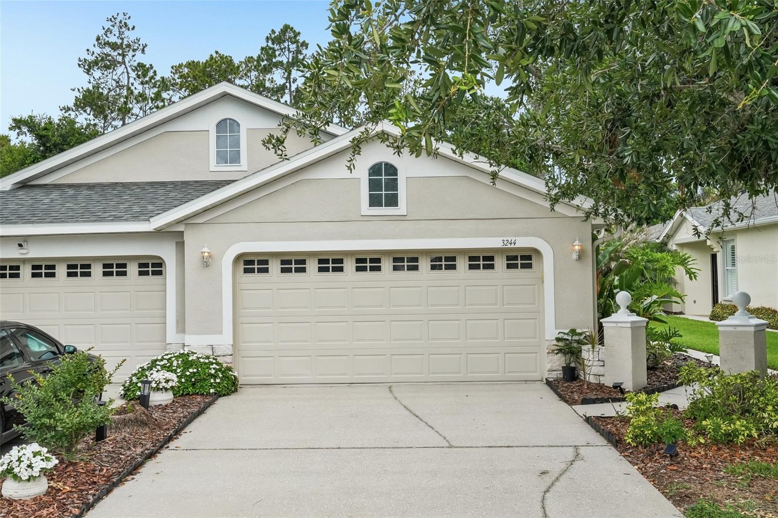 One or more photo(s) has been virtually staged. Located within the gated enclave of Willow Creek in Seven Oaks, this beautifully maintained 3-bedroom, 2-bath villa offers the perfect blend of comfort, style, and low-maintenance living. From the moment you enter, you are welcomed by high ceilings, elegant crown molding, and sophisticated tray ceilings that create an open and airy feel throughout the home. Fresh interior paint and brand-new carpet provide a crisp, move-in-ready appeal, while plantation shutters add timeless charm and character to the living spaces. Designed with both functionality and privacy in mind, the thoughtfully crafted split-bedroom layout offers comfortable everyday living as well as an ideal setup for guests. Completing the home is a spacious 2-car garage and an inviting atmosphere that combines refined finishes with effortless comfort.The inviting kitchen boasts generous cabinetry, sprawling countertops, a breakfast bar, and brand-new stainless appliances including a range, dishwasher, and microwave. The spacious primary suite is a true retreat with dual closets, dual sinks, a relaxing garden tub, upgraded lighting fixtures, and private sliding glass doors leading directly to the oversized screened-in lanai.Enjoy peaceful outdoor living with no rear neighbors, exceptional privacy, and an extendable awning that creates the perfect shaded space for relaxing or entertaining. Best of all, the HOA covers exterior maintenance, lawn care, landscaping, roof replacement, and exterior painting, allowing for truly carefree living. Residents of Willow Creek enjoy access to their own private community pool as well as all the exceptional amenities of Seven Oaks, including heated resort-style pools, a clubhouse, fitness center, tennis and pickleball courts, basketball court, soccer field, playgrounds, and scenic walking and biking trails. Conveniently located near major highways, medical centers, shopping, and dining, this villa offers the ideal combination of luxury, convenience, and lifestyle.