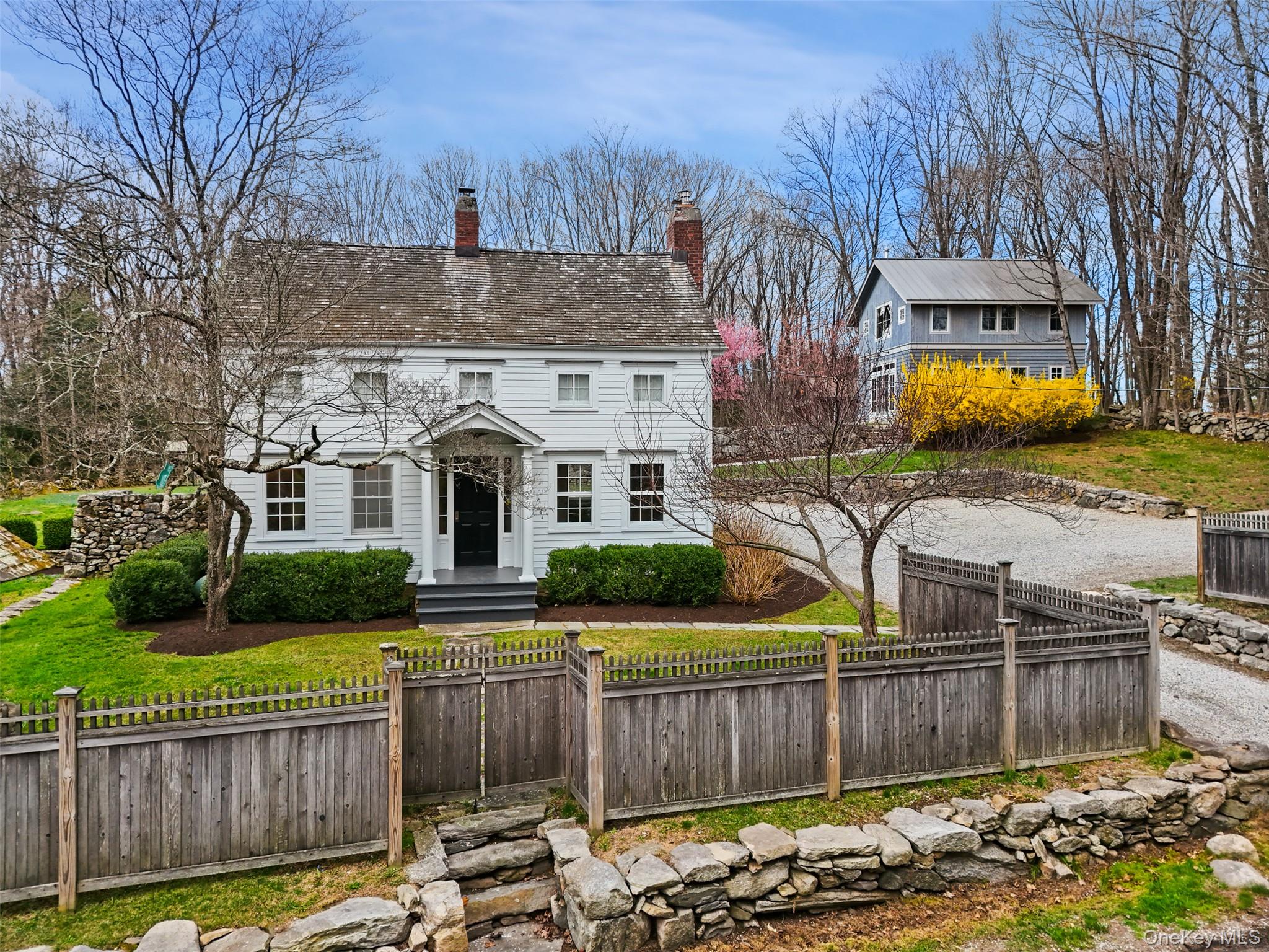 RESTORED 1800'S COLONIAL. A perfect “new” old house! Circa 1800 Center Chimney Colonial with amazing golf course views. Wide board oak floors, two fireplaces and antique charm. Pillared Portico. Sun-filled Living Room with decorative fireplace. Formal Dining Room with fireplace, beehive oven and original Parson’s Cupboard. Beautiful Kitchen with white marble countertops and door to rear dining terrace. Family Room with Full Bath. Sun-filled Primary Bedroom with door to marble Bath. Two additional Bedrooms. One acre with gently rolling lawns, old stone walls and spectacular plantings. wishing well. Fabulous Two-Story Barn, approximately 1000 square feet,  offering a myriad of uses including Studio/Office space, Gym, Party Barn or Guest Quarters. Detached Two-Car Pole Barn. Easy Merritt commute. Absolute perfection!