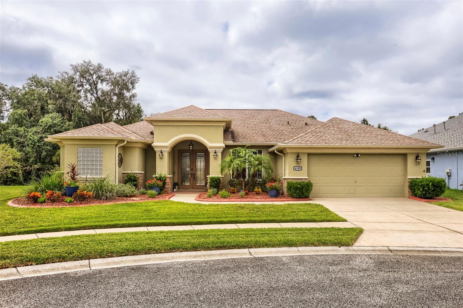 Welcome to this stunning golf course community, complete with a pro shop and restaurant. Recently added, the community now features two pickleball courts. This beautiful gated community is surrounded by lush conservation areas and offers spacious homesites.This remarkable home boasts 4 bedrooms, 2 bathrooms, and a 3-car tandem garage, perfectly situated on a cul-de-sac lot with conservation views. A sparkling screened-in swimming pool adds to the appeal. Upon entering, you are greeted by double doors leading to a formal living room adorned with a double-tiered tray ceiling and a breathtaking view of the pool and conservation area. The spacious formal dining room is ideal for hosting holiday gatherings.The kitchen is a chef's dream, featuring upgraded cabinetry, a glass cooktop range with a matching wall-mount hood, a high-end refrigerator, and a countertop microwave, all with ample space for food preparation and serving. The bar top island provides additional seating and serving space. There is a separate morning room with a miter-glass window and sliding doors that overlook the pool and conservation area, perfect for extra seating during gatherings. The large leisure room comes equipped with an entertainment center, making it perfect for family movie and gaming nights.The secluded master suite includes a private entry to the lanai and pool area, spacious walk-in closets, and an en-suite bathroom with his and her vanities, a 6-foot soaking tub, and a separate shower. Two generously sized secondary bedrooms each feature walk-in closets, and the guest/den room offers double closets along with a private entrance to the lanai and pool area.The beautifully maintained pool area is surrounded by upgraded coping and pavers, while a spacious rear yard provides ample space for family fun and pets. Call today for your private showing!