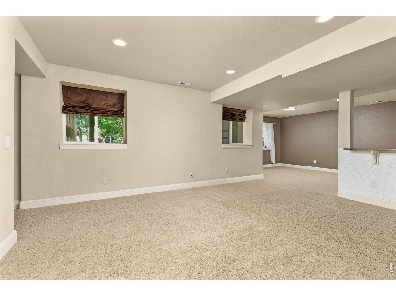 Welcome home to this beautifully maintained ranch-style home offering the perfect blend of comfort, functionality, and space in a desirable Windsor location. Featuring five bedrooms and three bathrooms, this thoughtfully designed home boasts an open floor plan with high ceilings and durable laminate flooring throughout the main living areas.The spacious kitchen is designed for both everyday living and entertaining, complete with stainless steel appliances, a center island, and a walk-in pantry. The adjoining dining area opens to a deck overlooking the expansive backyard, where mature landscaping creates a peaceful outdoor retreat. The inviting living room is filled with natural light and centered around a cozy gas fireplace, making it the perfect gathering space year-round. The main-floor primary suite offers a private escape with a luxurious five-piece bath, heated floors and a large walk-in closet featuring extensive shelving and storage. Downstairs, the garden-level basement expands the home's living space with a spacious family room, convenient kitchenette, two additional bedrooms, and ample room for guests, hobbies, or multi-generational living. Two separate unfinished storage areas provide exceptional flexibility for organization or future customization. An oversized three-car garage offers plenty of room for vehicles, recreational equipment, and workshop space. Class 4 impact resistant shingles complete the roof. Ideally situated near shopping, restaurants, golf courses, parks, and entertainment, this home combines everyday convenience with comfortable living in one of Windsor's most sought-after communities.