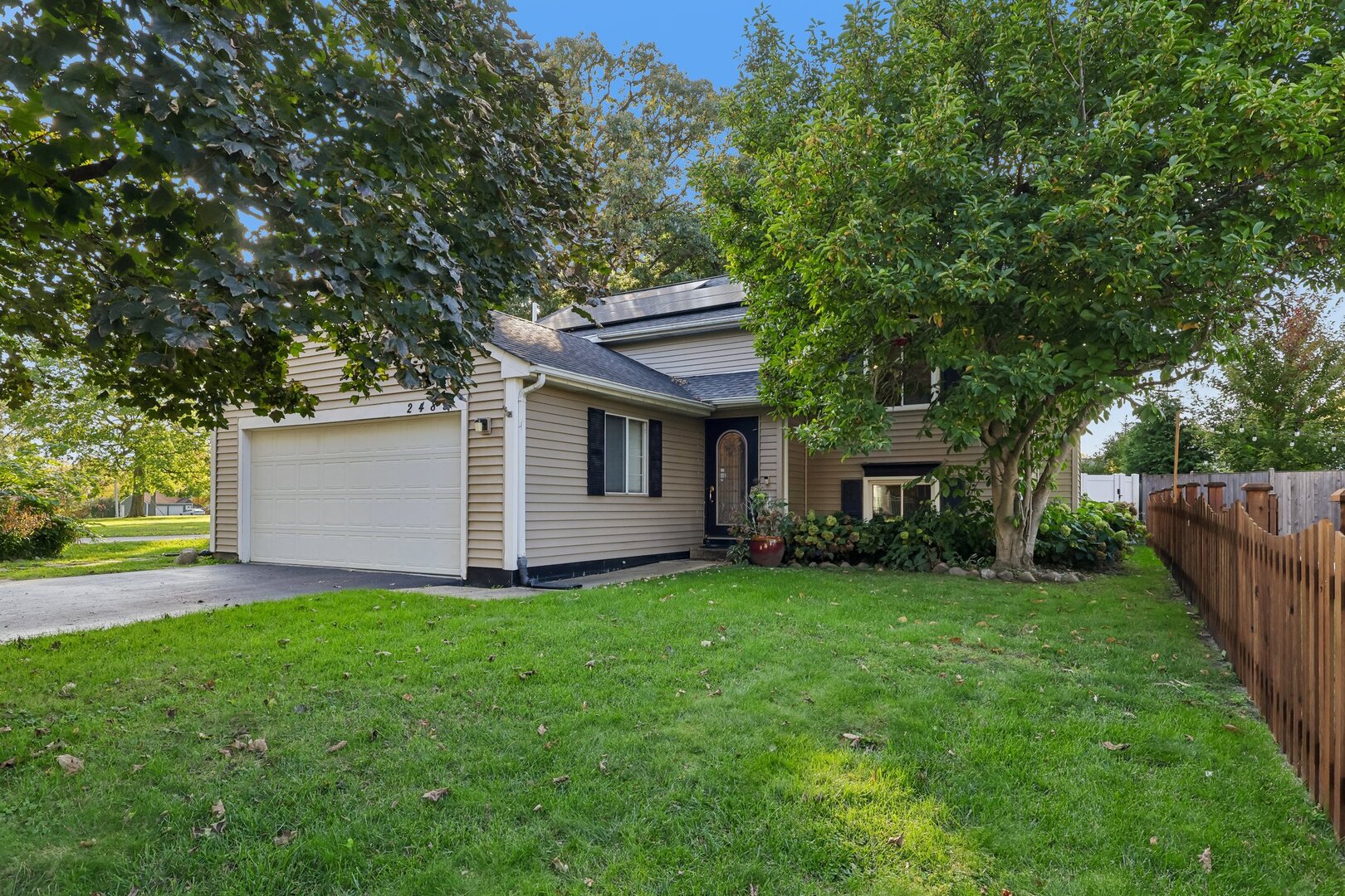 Welcome to 2489 Willoughby Ln in Aurora, IL! This updated 3-bedroom, 2-bath raised ranch in the desirable Indian Prairie School District 204 offers modern comfort, energy efficiency, and inviting indoor-outdoor living. This home features vaulted ceilings, wood laminate flooring, and an updated kitchen with custom cabinetry, stainless steel appliances, and a center island. The kitchen and dining area flow seamlessly for everyday living and entertaining. The lower-level includes a family room, two additional bedrooms, and a remodeled full bathroom (2022). Enjoy relaxing outdoors on the screened porch or spacious deck, with extra storage beneath the deck. Energy-efficient upgrades include triple-pane windows (~2021), a three-zone mini-split heat pump (~2020), owned solar panels installed in 2024 with a 7.6 kW system, a new sump pump (2025), and a new furnace (2026). The attached 2.5-car garage includes a dedicated 50-amp, 240V circuit ready for electric vehicle charging. Additional updates include a water heater installed in 2017. The owned solar system offers the potential for significant electricity savings, with low electric bills reported by the owner. Conveniently located in Aurora, with access to shopping, dining, parks, and major commuter routes. Served by Brooks Elementary, Granger Middle School, and Metea Valley High School in District 204. If you're searching for an updated Aurora home with solar panels, EV charging capability, a finished lower-level living area, and outdoor entertaining space, this home is a must-see! Property is being offered as-is.