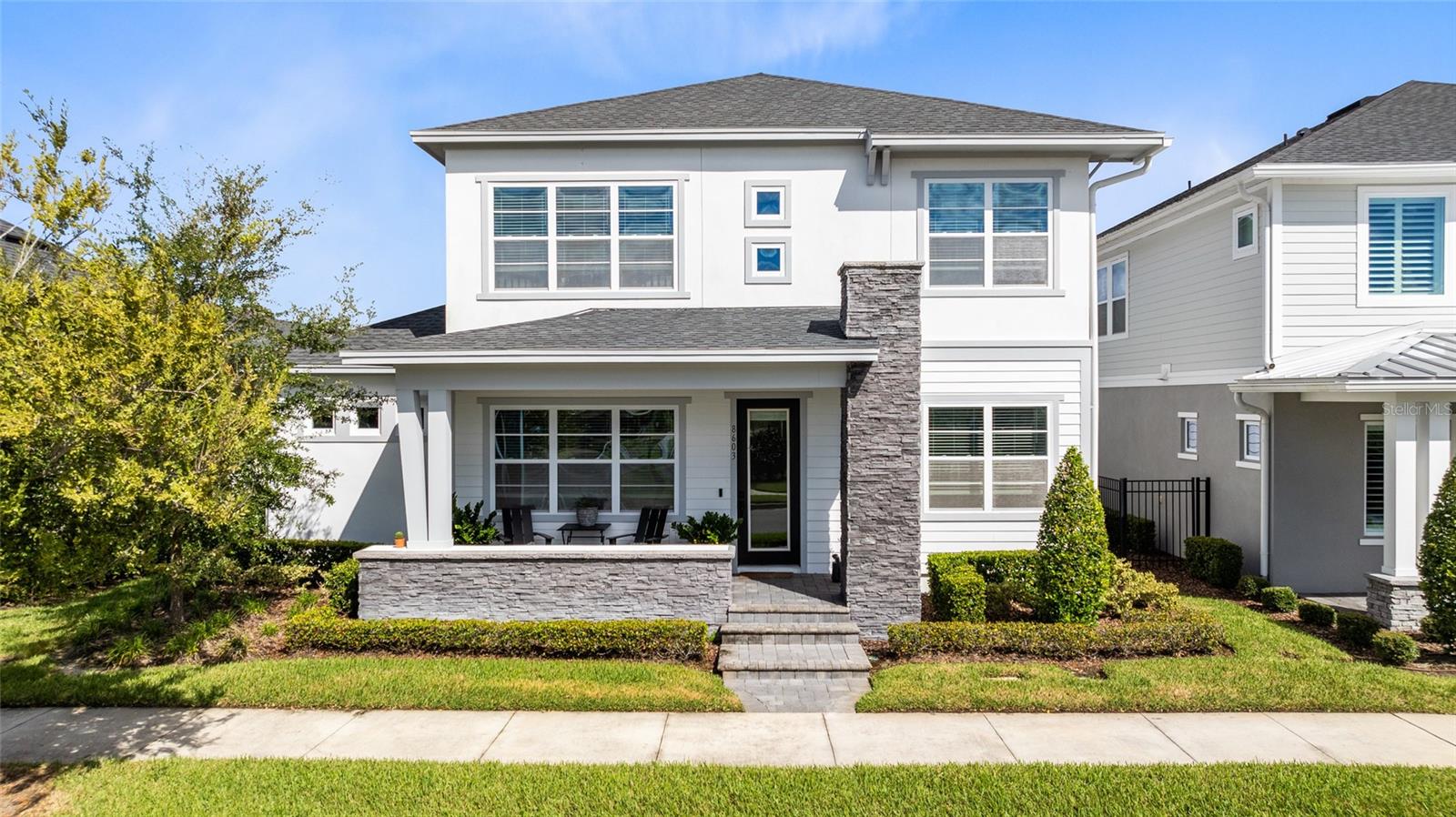 Welcome to this beautifully maintained David Weekley Sunnybrook model, offering over 3,000 sq. ft. of bright, open living in the heart of Laureate Park. The home’s crisp exterior, stacked-stone accents, and inviting front porch create standout curb appeal. Inside, large windows and tall ceilings fill the first floor with natural light, complementing the wood-look flooring and spacious layout. A dedicated home office sits at the front of the home, ideal for work or flexible living. The gourmet kitchen overlooks the living and dining areas and features 42" white cabinetry, quartz countertops, stainless-steel appliances including a built-in oven and microwave, cooktop, a large island with seating, and a modern tile backsplash. The first-floor primary suite offers a peaceful retreat with a tray ceiling, generous natural light, and an expansive walk-in closet with built-in storage. The spa-inspired bath includes dual vanities, quartz counters, sleek black hardware, a frameless walk-in shower, and direct access to the oversized closet. A secondary bedroom and full bath on the main level provide an ideal guest suite. Upstairs, a spacious loft anchors the second floor and is perfect for a media lounge, playroom, or additional gathering space. Two well-sized bedrooms and a full bath complete the upper level, offering privacy and comfort for family or guests. The covered lanai steps out to a fenced backyard with room to relax, grill, and enjoy Florida living year-round. Located within the vibrant Laureate Park community, enjoy access to the Aquatic Center, LP Fit gym, playgrounds, dog parks, community gardens, and 44+ miles of walking, running, and biking trails. All just minutes from Medical City, the VA Hospital, Nemours Children’s Hospital, USTA National Campus, dining, shopping, and major highways.