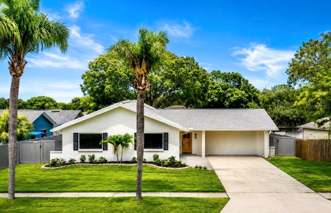 Nestled in one of Dunedin’s most sought-after neighborhoods, beautifully renovated, completely move-in-ready pool home offering an exceptional combination of location, quality, and lifestyle. Situated within golf-cart distance of vibrant Downtown Dunedin and just steps from the world-famous Toronto Blue Jays Spring Training facility, this home places you in the heart of one of Florida’s most charming coastal communities. Enjoy easy access to the Pinellas Trail, waterfront parks, marinas, local breweries, award-winning restaurants, boutique shopping, and year-round events that make Dunedin such a special place to call home. Meticulously improved from top to bottom, this home has undergone an extensive transformation, with all improvements having been properly permitted. The centerpiece of the renovation is the stunning 2026 interior remodel, which completely reimagined the home with today’s buyer in mind. New flooring extends throughout the entire residence and is complemented by custom baseboards, updated door frames, new hardware, decorative lighting, fresh interior and exterior paint using premium Sherwin-Williams products, and thoughtfully selected finishes that create a cohesive and elegant feel throughout.The beautifully remodeled kitchen serves as the heart of the home, featuring high-end cabinetry accented with crown molding, dark stainless-steel appliances, a built-in wine refrigerator, and a dedicated coffee bar designed for both everyday living and entertaining. The bathrooms have also been transformed, including a luxurious primary suite bath and a beautifully renovated family bathroom. Custom closets and new closet doors throughout the home provide both style and functionality. Significant investments have been made in the home’s major systems. A new air conditioning system was installed in 2026, providing energy-efficient comfort and peace of mind. The home is also equipped with a Generac whole-house generator installed in 2021. Additional upgrades include new whole-house insulation featuring advanced pest-resistant technology, a new sprinkler irrigation system, updated decorative electrical outlets and switches throughout, and numerous improvements that enhance both comfort and efficiency.The outdoor living spaces are equally impressive. The backyard has been upgraded with premium turf, creating a lush, low-maintenance environment perfect for relaxing, entertaining, or enjoying Florida’s beautiful weather year-round. New pavers create an inviting front entry, while professional landscaping in both the front and rear yards enhances the property’s curb appeal. A new vinyl privacy fence installed in 2025 surrounds the pool area and backyard, offering security, privacy, and a polished finish to the outdoor space. Adding even more versatility is the customized garage retreat, complete with a workbench, refrigerator, cabinetry, drawers, and dedicated workspace. Whether used as a man cave, workshop, hobby room, fitness area, or additional entertaining space, this unique feature adds tremendous value and functionality. Every detail of this home has been thoughtfully upgraded with quality materials and professional craftsmanship. From the 2026 interior renovation and new 2023 A/C system to the 2025 fencing, 2021 whole-house generator, modern kitchen, beautifully updated bathrooms, and low-maintenance outdoor spaces, 1591 Cottonwood Terrace offers the perfect blend of luxury, comfort, and peace of mind.
