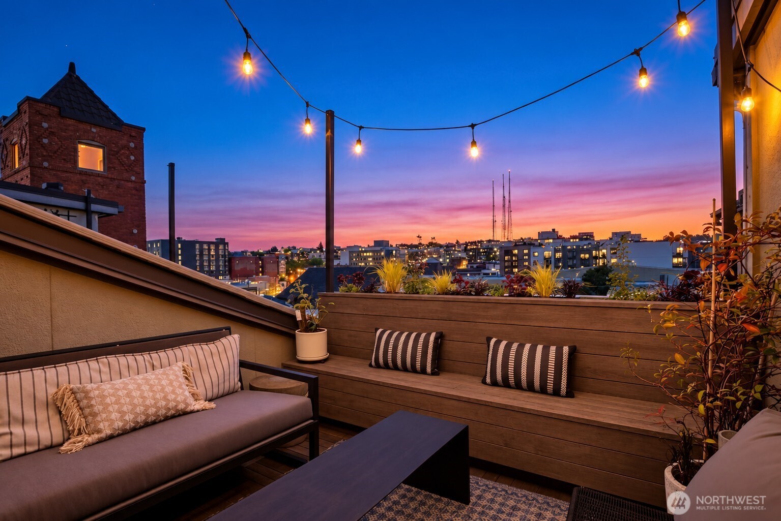 Immerse yourself in NYC style from the moment you step into this one-of-a-kind loft in iconic Firehouse 25. Fully reimagined from the ground up for today’s comfort, while keeping its 1908 historic details intact - a rare treasure in Seattle. Grand open spaces with original brick walls create the perfect gallery for your art collection. Full-height arched windows bathe the home in natural light while preserving  its moody, stylish vibe. Steel beams against crisp white walls, wide plank flooring, and soaring ceilings over 10 ½ ft make it iconic in every way. Built with entertaining in mind, the spacious dining room opens to the renovated kitchen with Caesarstone counters, a rich wood bar, and beautiful custom cabinetry, along with a generous butler’s pantry with wine storage. A show-stopping staircase rises alongside floor-to-ceiling built-ins, creating a curated library for books, travel mementos and memories. Upstairs is the primary suite, a second guest/flex space, and two fully renovated baths, all crowned by 2 outdoor spaces - your oasis in the middle of the city. The terrace off the primary bedroom offers a quiet sanctuary for morning coffee in a garden setting. The balcony off the flex space is a special gathering spot for summer dinner parties or casual afternoons in the outdoor living room. String lights and a lush garden with a fully integrated drip system make it effortless to enjoy. 2 large underground parking spaces and 2 storage areas complete the package.
