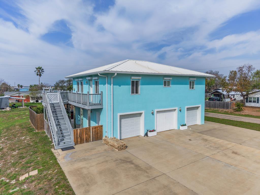 Island -Style Coastal Living just blocks from the bay!  Experience relaxed coastal living in this beautiful island-style home, perfectly positioned just blocks from the bay in the heart of Ingleside.  With water views, abundant natural light, and a spacious three-car garage, this home offers the ideal balance of comfort, style, and location for those who want to live near the coast without sacrificing convenience.  Inside, an open-concept living area is framed by large windows that fill the home with sunshine and showcase serene coastal views.  Two generously sized bedrooms provide peaceful retreats, while the expansive primary suite features a large walk-in closet with additional flex space - perfect for a private office, sitting area, or creative studio.  Outdoor lift already in place for your convenience.  Step outside to enjoy a beautiful, private outdoor living space designed for entertaining, relaxing, and soaking in the coastal breeze.  Whether you're grilling with friends, enjoying morning coffee, or unwinding in your hot tub after a day on the water, this space invites you to fully embrace the island lifestyle.  This double lot still has plenty of room for boat storage and more!  Just minutes from the marina and boat ramp, world-class fishing and boating are right at your fingertips.  At the same time, you're conveniently close to shopping, dining, and employment hubs in Corpus Christi, Portland and Ingleside - making this home as practical as beautiful.  This is coastal living done right:  light-filled, well-designed, and perfectly located near the water while staying connected to everything that matters.