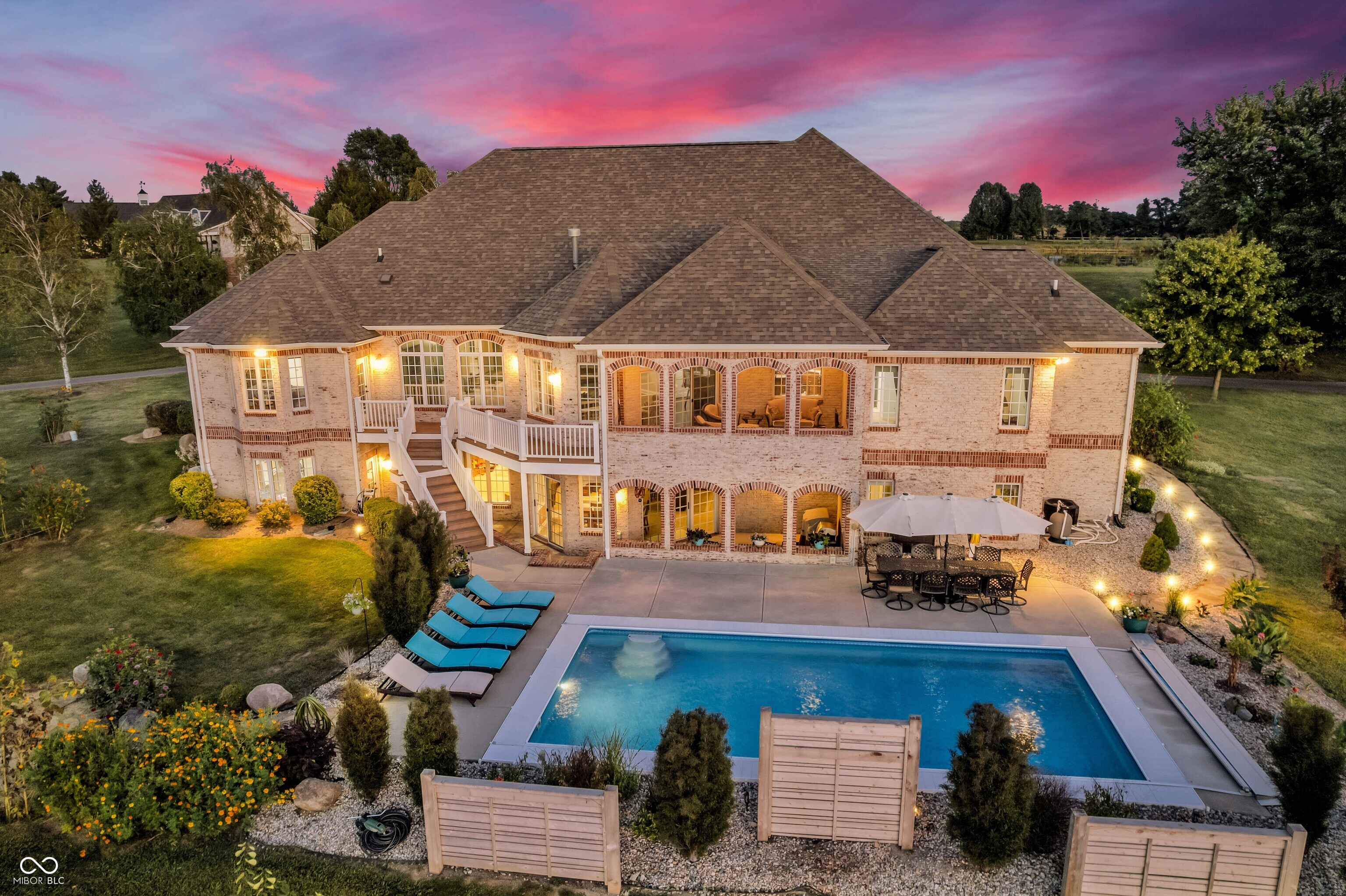 Nestled on 5.4 acres of beautiful property in Franklin, this stunning home blends luxury, comfort, and endless opportunities for entertaining. With 7,128 sqft (5,826 sqft finished), 4 bedrooms, 3.5 baths, 4 car garage, large walkout basement, three covered outdoor bricked patios, heated saltwater pool, and so much more - there's plenty of room for family and friends to gather and for you to find your retreat. Step inside to a bright open great room with vaulted ceilings, expansive windows and a double-sided fireplace that also faces a sitting room that overlooks the large backyard. The gourmet kitchen has a large island, corian counters, double oven, reverse osmosis system, appliance garage, walk-in pantry and under cabinet lighting. The home also features a formal dining room that is perfect for gatherings. The main floor features beautiful Mohawk Engineered Hardwood Handscraped floors. A bright home office provides the ideal space for working or studying. The primary suite is a private retreat with direct private access to the backyard oasis, complete with a luxurious spa-inspired bathroom featuring dual vanities, a walk-in shower, and a large walk-in closet. Downstairs, the expansive basement offers a second family room, kitchen/bar, an additional bedroom and extraordinary storage space. Note all the bedrooms are nice size thru-out and bedrooms #2 and #3 have a jack & jill bathroom.  The unfinished part of the basement offers space to customize and add to the home or use for fantastic storage space. The home is also setup with a Sonos Sound System, so you can enjoy your favorite music inside and outside. Outdoor living is equally impressive - Stunning landscaping covers the property and provides additional privacy, along with custom wood privacy screens by the pool. You can also gather around the outdoor fire pit. Whether it's morning coffee, cookouts, or soaking in the beautiful sunrises & sunsets - this property delivers every detail! Welcome Home!