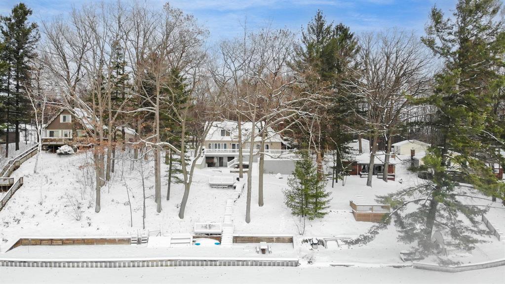 Welcome to this stunning lakeside retreat at 7670 Five Lakes Dr, Farwell, MI! Nestled on over an acre of picturesque waterfront land, this enchanting 4-bedroom, home offers lakefront living with over 105 feet of water frontage and mesmerizing lake views. Step inside to be greeted by a spacious, sunlit kitchen adorned with rich, dark wood cabinetry, sleek stainless-steel appliances (chefs stove), and a stylish countertop island. A cozy family room with wood-burning fireplace. The huge living room, featuring a warm fireplace (gas), provides a perfect place for relaxation and enjoyment with the extended family. The inviting multi-level deck, seamlessly accessible from the living areas, provides an idyllic space for outdoor entertaining with serene lake views as your backdrop. Imagine evenings by the outdoor fire pit, with lush green trees all around. Additional features of this impressive property include a 24 kw Generac generator (2022), two new furnaces (2024), two new central air units (2024), roof (2018), and a newer water treatment system. A relaxing spa adds a touch of luxury to this already impressive home. Two wooded lots across the street offer opportunities for additional building. Surrounded by beauty and designed for comfort, this captivating lakeside home is one of the largest on Five Lakes which is an all sports lake. Experience the perfect blend of nature and modern living at this charming Lakehouse. This home is ADA accessible with Chair lifts (negotiable) and grab bars. Dont miss your chance to call this tranquil retreat your own.