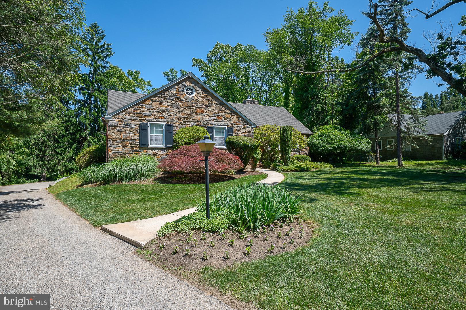 Welcome to this spacious 3 bedroom, 2 full bath home ,situated on an acre property on a quiet tree lined street in the highly desirable Penn Valley neighborhood of Lower Merion School District. This home offers a rare combination of character, functionality and opportunity. Step into the welcoming foyer. To the right you'll find an expansive living room drenched in natural light on two sides with a beautiful gas fireplace. The living room flows into a large sunlit dining room with hardwood flooring. Beautiful hardwood flooring is located under all carpeted areas of the entire first floor. A cozy den/office with wet-bar and access to the rear yard is located off the living room. The updated, eat in kitchen ,with access to the rear yard is located in the center of the home next to the dining room. The spacious primary suite offers a full wall of custom built in closets, 2 additional closets, and a recently renovated bath with stall shower.Two additional bedrooms and a spacious updated hall bathroom complete this level. The attic is partially finished with flooring and a bathroom. This level offers plenty of storage and endless possibilities for expansion. Laundry is located in the unfinished lower level.  This expansive space with walk out access to the rear yard also provides abundant storage and exciting potential for future finishing to create additional living or recreational space. Enjoy the tranquility of the spacious yard from the covered patio. The separate 2 car garage is located behind the house with easy access to the lower level. The generator offers peace of mind &  convenience. The newer roof was replaced in 2022. Ideally located just minutes from major roadways for easy access to Center City.