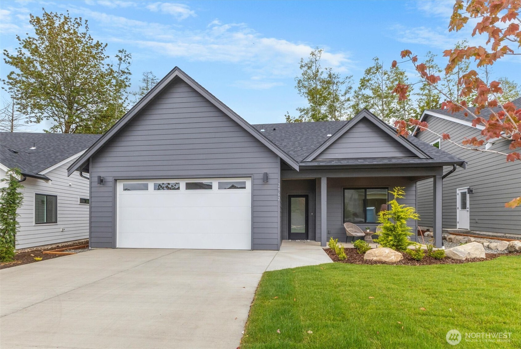 Blaine, WA | 4BD / 3BA | $5,000 Seller Credit + Lender IncentivesThe Ridge, this 4-bedroom home is one of its finest offerings. Designed for modern living with finishes that genuinely impress, this is the one worth seeing in person. An open concept main level brings together a chef-inspired kitchen, propane fireplace, and generous living area in a layout that invites both quiet evenings and lively gatherings. Flat panel cabinetry, quartz countertops, and upgraded appliances deliver a polished look that feels curated, not cookie-cutter. Premium hybrid flooring runs throughout, combining 100% waterproof protection with scratch-resistant durability that holds up beautifully to real life. Retreat to the spacious main floor primary suite featuring a tile walk-in shower, double vanity, large walk-in closet, and plenty of natural light. A fourth bedroom on the main level offers the perfect setup for a home office, guest room, or flex space. Upstairs, two additional bedrooms provide comfortable, private spaces. The expansive covered back deck extends your living space outdoors year-round, and an EV charger in the garage means you're already ahead of the curve. What sets this home apart; Main floor primary suite with spa-inspired ensuite. Flexible fourth bedroom on main level. Premium waterproof hybrid flooring. Propane fireplace and upgraded appliances. EV charger included. $5,000 seller credit + lender incentives. Minutes to I-5, the Canadian border, and downtown Blaine.