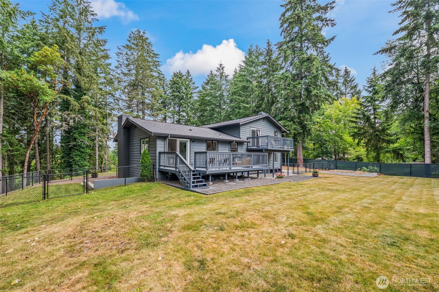 Fun meets Function! Tucked into 2.18 private acres in Rosedale, this move in ready charmer is surrounded by parks east & west —with a hidden trail to Sehmel Park just steps from your driveway. The fully fenced yard is a playground for all, with sunny garden beds, RV parking, loads of deck space, & trails.  Inside, you’ll find 4 beds, 2.5 baths, fresh finishes, and a flexible lower-level space with its own entry—perfect for guests, game nights, home office, or multi-gen living. Solid 70s construction meets today’s style & comfort with multiple living areas, a bright kitchen, & 3 cozy fireplaces. Peace, privacy, & adventure? Right out your door!  All this minutes from top-rated schools, shopping, charming downtown Gig Harbor & NO HOA!