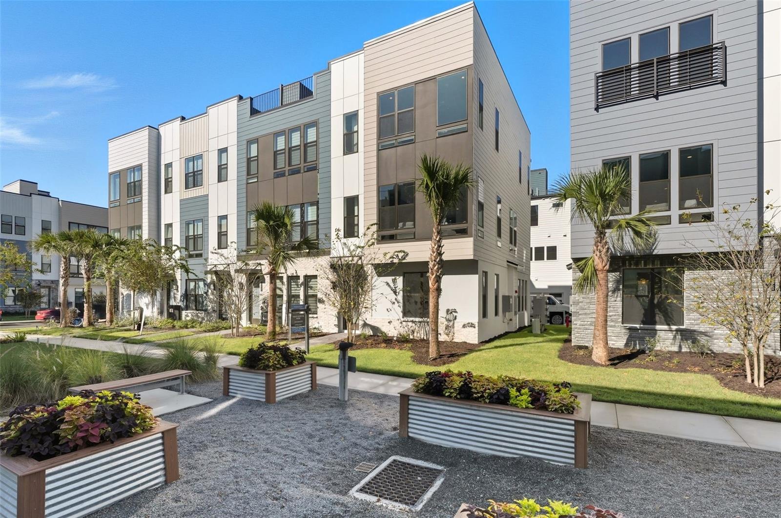 MOVE-IN READY Luxury Townhome with Rooftop Terrace in The Packing District! Welcome to a lifestyle of comfort, convenience, and modern elegance. This 4-story, move-in ready townhome is designed for effortless living and entertaining in one of Orlando’s most exciting new communities — The Packing District. On the first floor, you’re greeted by a private office with its own full bathroom, perfect for working at home or hosting guests, along with a spacious two-car garage. The second floor is your main living area, featuring an open-concept layout with a gourmet kitchen, casual dining area, and a light-filled great room perfect for relaxing or hosting. You'll love the upgraded grey cabinetry, quartz countertops, stunning white tile backsplash, and included natural gas KitchenAid appliances, all thoughtfully selected to elevate your day-to-day living. Head up to the third floor, where you’ll find the primary bedroom retreat, a secondary bedroom, and a walk-in laundry room for ultimate convenience. And then, the crown jewel, the fourth-floor rooftop terrace. Your private outdoor oasis comes equipped with pre-installed prep packages ready for a future summer kitchen, fireplace, and even a hot tub. Imagine sunset dinners, weekend lounging, and unforgettable evenings under the stars — all from the comfort of home. Interior upgraded finishes throughout include: Engineered hardwood stairs, Luxury vinyl flooring in main living areas, Luxury vinyl in all bedrooms, Quartz countertops and upgraded cabinetry. The on-site model home showcases a similar layout, we invite you to come and experience it in person! Living in The Packing District means so much more than just having a beautiful home, it’s about embracing a dynamic, connected lifestyle. Start your day with a peaceful walk or bike ride along the scenic 1.5-mile trail, then grab a slice at the food hall or break a sweat at the brand-new YMCA. Meet up with friends for a competitive game of pickleball or tennis at the Orlando Tennis Center — all just steps from your door. And the amenities don’t stop there. The Packing District is growing into one of Orlando’s most exciting new communities, featuring a new Publix, rock climbing facility, Hotworx Studio, and the innovative 4Roots Farm Campus. With future office and retail spaces also in the works, everything you need from wellness to convenience to recreation, its right at your fingertips