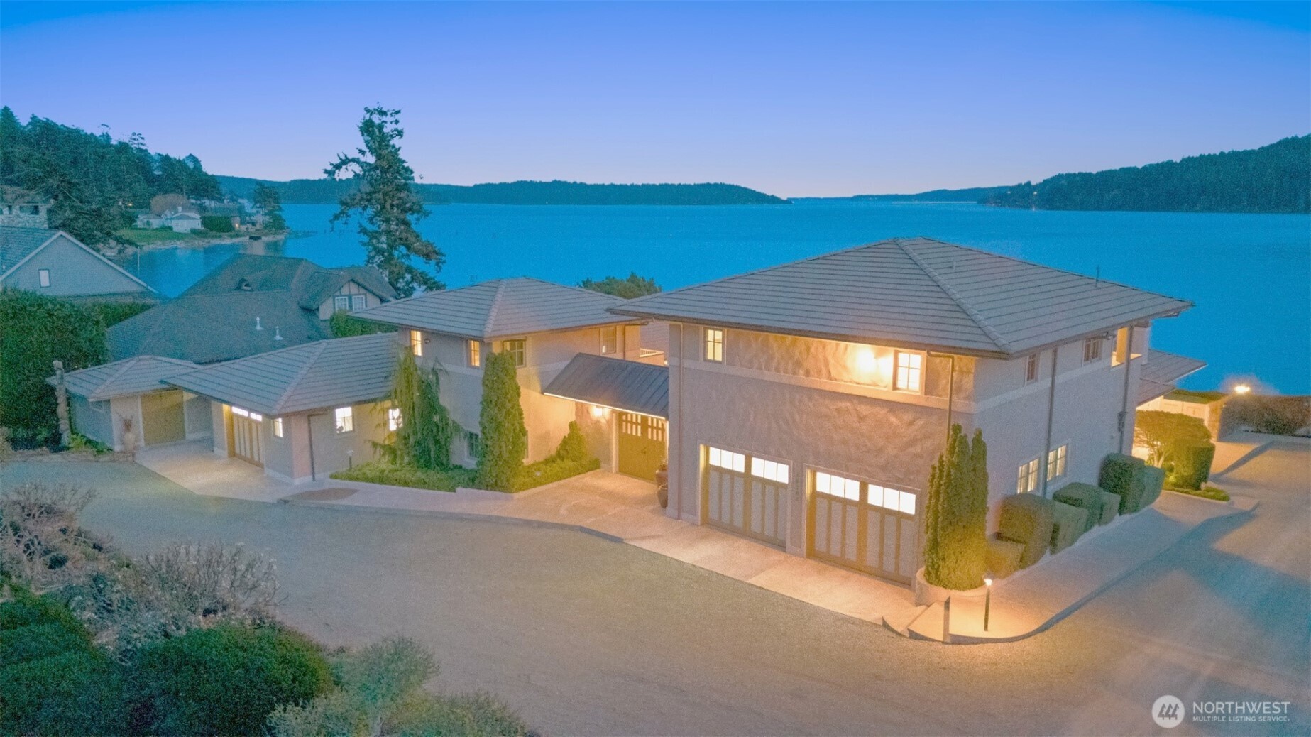 Experience timeless elegance and refined coastal living in this extraordinary Mediterranean-inspired waterfront estate in Anacortes with 146’ of coveted south-facing, medium-to-low bank beach frontage on Skagit Bay. Privately set on .85 acres, this custom designed home offers breathtaking panoramic bay and island views from nearly every room. A private gated Tuscan-style courtyard with a beautiful fountain leads to a residence defined by craftsmanship and enduring quality. Built with durable steel-framed construction and lock-in-place foundation, wrapped in classic old-world stucco, featuring copper gutters and trim, Monier cement tile roof, and Marvin steel-clad windows. Interior highlights include travertine floors, custom VG fir doors, bespoke cabinetry and a striking great room with fireplace and commissioned glass art. Open chef’s kitchen with butler’s pantry are equipped with Sub-Zero & Wolf appliances, offering seamless entertaining. Luxurious primary suite with spa-style bath, sauna, steam shower & views. Two upper-level guest suites with en-suite baths, kitchenettes and panoramic vistas. Library/4th bedroom option with adjacent ¾ bath, office, den with fireplace & view deck, plus separate garden/artist studio. A grand terrace with a wide lighted staircase leads to the beach, fire pit and bulkhead. Radiant heat, integrated sound system, 200-amp whole house generator, security system, and 9-zone sprinkler system.  Two garages with ample guest parking.