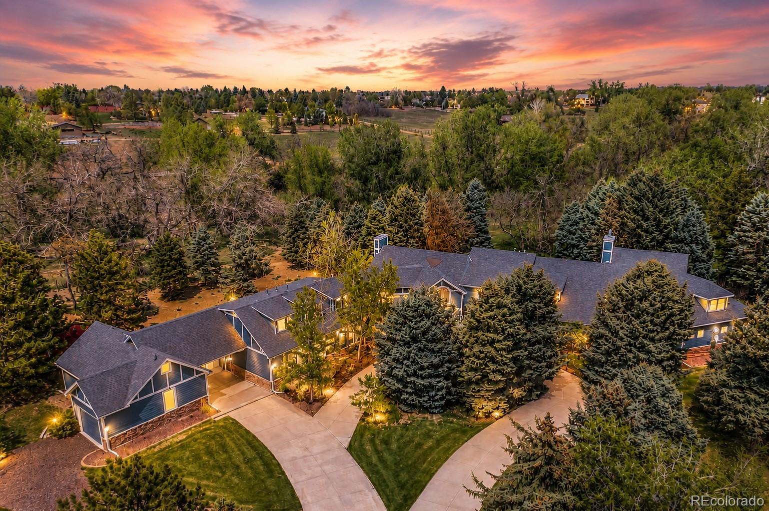 Discover a rare opportunity to own a private luxury estate on 2.33 breathtaking acres in the heart of Greenwood Village. Surrounded by mature landscaping and a picturesque creek, this exceptional property blends refined elegance, comfort, and Colorado living at its finest.Designed for both entertaining and everyday living, the home features five spacious ensuite bedrooms and six beautifully appointed bathrooms. The luxurious primary suite offers a cozy fireplace, private wet bar, dual oversized walk-in closets, and a spa-inspired bath with heated floors and an additional fireplace. A private loft just off the suite creates the perfect space for a home office or quiet retreat.The chef’s kitchen is a true centerpiece with two oversized islands, three ovens, a six-burner gas range, dual dishwashers, and an expansive walk-in pantry. A private main-level guest suite provides ideal accommodations for visitors or multi-generational living.Upstairs, two additional ensuite bedrooms feature plantation shutters and custom built-ins, while one includes a charming hidden playroom. The attached three-car garage offers generous storage and convenience.Adding incredible flexibility, the separate in-law residence includes its own two-car garage, full kitchen, laundry room, spacious living area, and a large bedroom sized for a king bed, making it perfect for guests, extended family, or private quarters.Outside, enjoy three inviting patios, peaceful outdoor living spaces, and a beautifully appointed barn complete with a tack room and pasture. With horse zoning already in place, this remarkable estate is perfectly suited for equestrian living while remaining just moments from premier dining, shopping, and recreation.Private, peaceful, and truly one of a kind, this extraordinary property offers an unmatched lifestyle in one of Colorado’s most desirable communities.