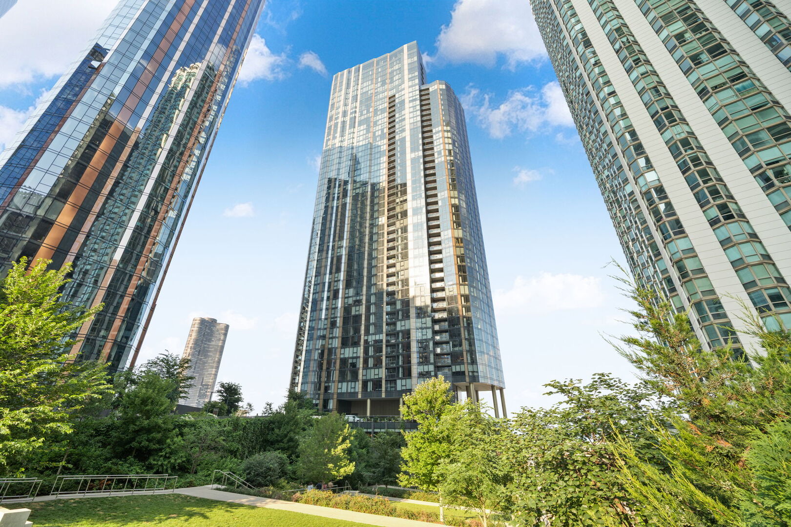 Welcome to your dream home in the sky-where luxury living meets a true sense of community, right in the heart of downtown Chicago. Tucked into the vibrant, lakefront enclave of Lakeshore East, this newer-construction high-rise condo blends high design with everyday convenience. Just steps from the lakefront, DuSable Harbor, Millennium Park, Mag Mile, and scenic bike paths, you're surrounded by iconic views and everyday convenience-grocery stores, cafes, restaurants, salons, and green parks all at your doorstep.  Inside, this condo is a masterclass in modern luxury. Floor-to-ceiling windows flood the space with light and offer jaw-dropping views of the city skyline, lakefront, and green spaces-each room feels like its own curated snapshot of Chicago. Whether it's sunrise over the lake from your living room or a glowing skyline at night, the views are the star of the show.  Design details shine throughout: gorgeous hardwood floors, custom Italian Snaidero cabinetry, quartz countertops, Gaggenau appliances, and Dornbracht fixtures. Storage is both beautiful and functional with custom-built closets throughout. A covered balcony gives you a peaceful retreat to enjoy the outdoors year-round. Includes one coveted parking space-a rare find in this location.  Cirrus offers over 48,000 square feet of thoughtfully curated amenities designed for wellness, work, and play. Residents enjoy a stunning 41st-floor indoor/outdoor amenity deck with panoramic lake and skyline views, a wine lounge, chef's table, catering kitchen, and outdoor grilling stations perfect for entertaining. Wellness is front and center with a state-of-the-art fitness center, strength and motion studios, complimentary daily fitness classes, massage suite, steam room, and hydrotherapy pools. Relax year-round in the indoor/outdoor pools with private cabanas, or take advantage of co-working spaces, a salon, kids' club, and indoor/outdoor dog runs. Unique perks like a soundproof jam room, screening room, conservatory, and sports simulator elevate daily living, while 24-hour door staff and a dedicated management team ensure a world-class residential experience.