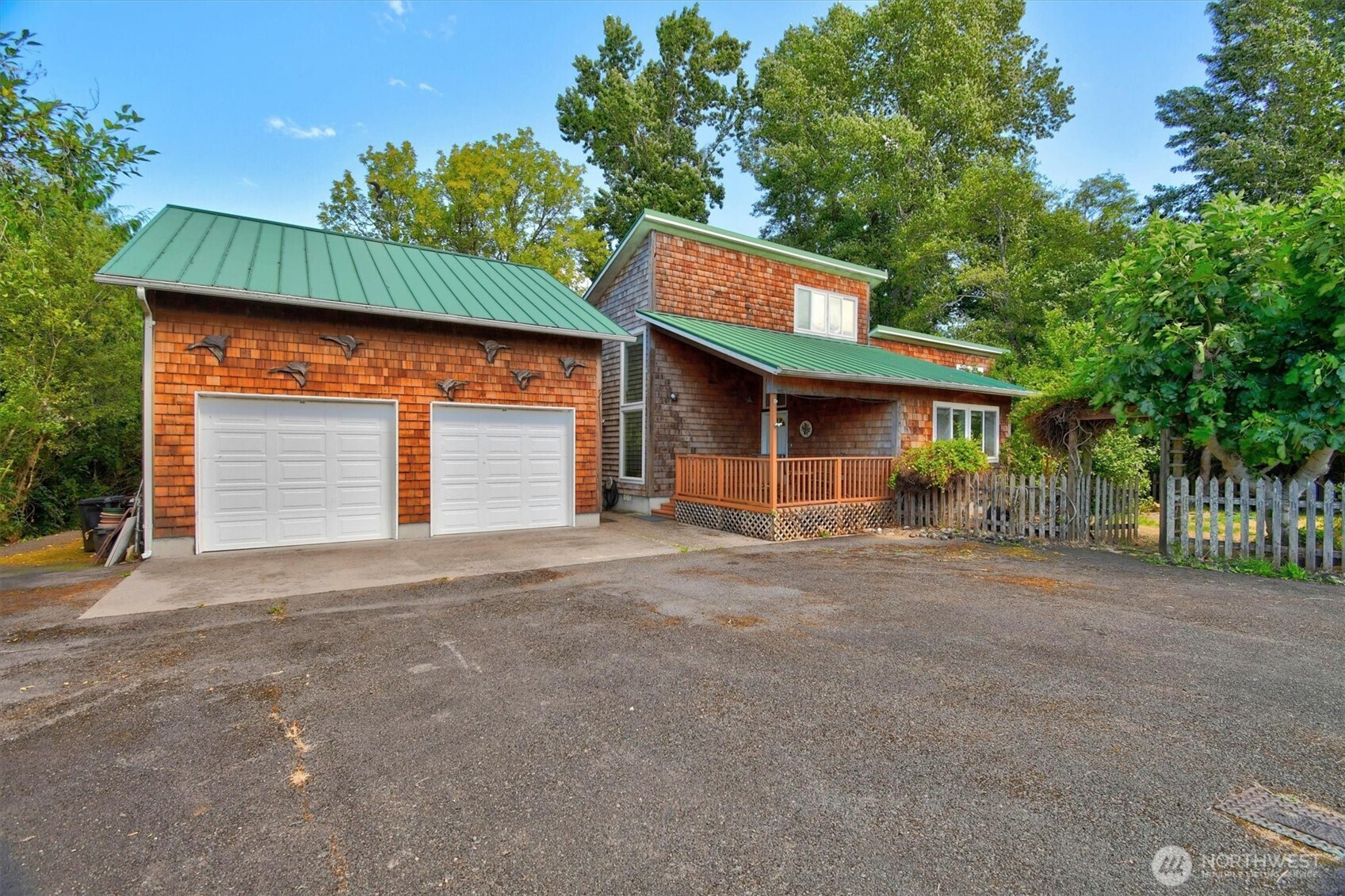 Discover the slower pace of island living in this custom cedar shake waterfront home on beautiful Puget Island. Offering 275' of waterfront, this thoughtfully designed home features comfortable main-level living with an open loft that's perfect for a home office, art studio, or creative retreat. Step onto the private back deck and soak in sweeping views of the water, surrounding hills, and abundant wildlife. A charming boardwalk winds through the trees to the shoreline where you can launch a kayak or canoe and explore the island's peaceful waterways. The detached two-car garage/shop includes a finished studio with a 3/4 bath and private balcony overlooking the water—ideal for guests, extended living, or potential rental income. Fruit trees welcome you home while deer, eagles, osprey, cranes, and other wildlife provide an ever-changing backdrop. Just minutes from the welcoming river town of Cathlamet, yet only a little over an hour from Portland or the Oregon Coast, this is the perfect place to unwind, reconnect with nature, and enjoy waterfront living at its finest.