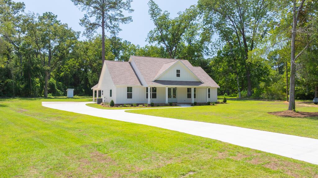 Welcome to 1435 Egg & Butter Road, offering approximately 2,690 square feet under roof on 1.26 acres, where thoughtful design, quality finishes, and country living come together just minutes from Thomasville.  This beautifully designed home offers a spacious, functional floor plan with high ceilings and abundant natural light throughout. The kitchen is built for both everyday living and entertaining, featuring quartz countertops, soft-close cabinetry, stainless steel appliances, a farmhouse sink, vent hood, built-in microwave, and a generously sized walk-in pantry conveniently located just off the kitchen.  Storage was clearly a priority in this home, with walk-in closets in every bedroom. The secondary bedrooms are complemented by a well-designed Jack-and-Jill bath with dual sinks, while the primary suite creates its own private retreat. The primary bath features a soaking tub, tiled walk-in shower, dual vanities, dedicated makeup area, and large walk-in closet. A sliding door connects the primary closet directly to the laundry room, where you'll find additional cabinetry, storage, and a utility sink.  Outdoor living is just as impressive. Both the front and rear covered porches feature real herringbone brick pavers, while the spacious rear porch with ceiling fans provides the perfect setting for afternoon relaxation, family dinners, cookouts, or entertaining friends.  The professionally landscaped 1.26-acre lot offers plenty of room to spread out, play, entertain, garden, or potentially add a future pool. Enjoy the privacy and peaceful feel of country living while remaining conveniently close to Thomasville.  Additional features include a two-car attached carport, new well, large backyard, professionally landscaped grounds, and a floor plan designed with flow, convenience, and everyday living in mind.  1435 Egg & Butter Road isn't just about square footage—it's about how well the space lives. This one truly needs to be experienced in person.      Seller is a licensed Real Estate Broker in the State of Georgia #340473