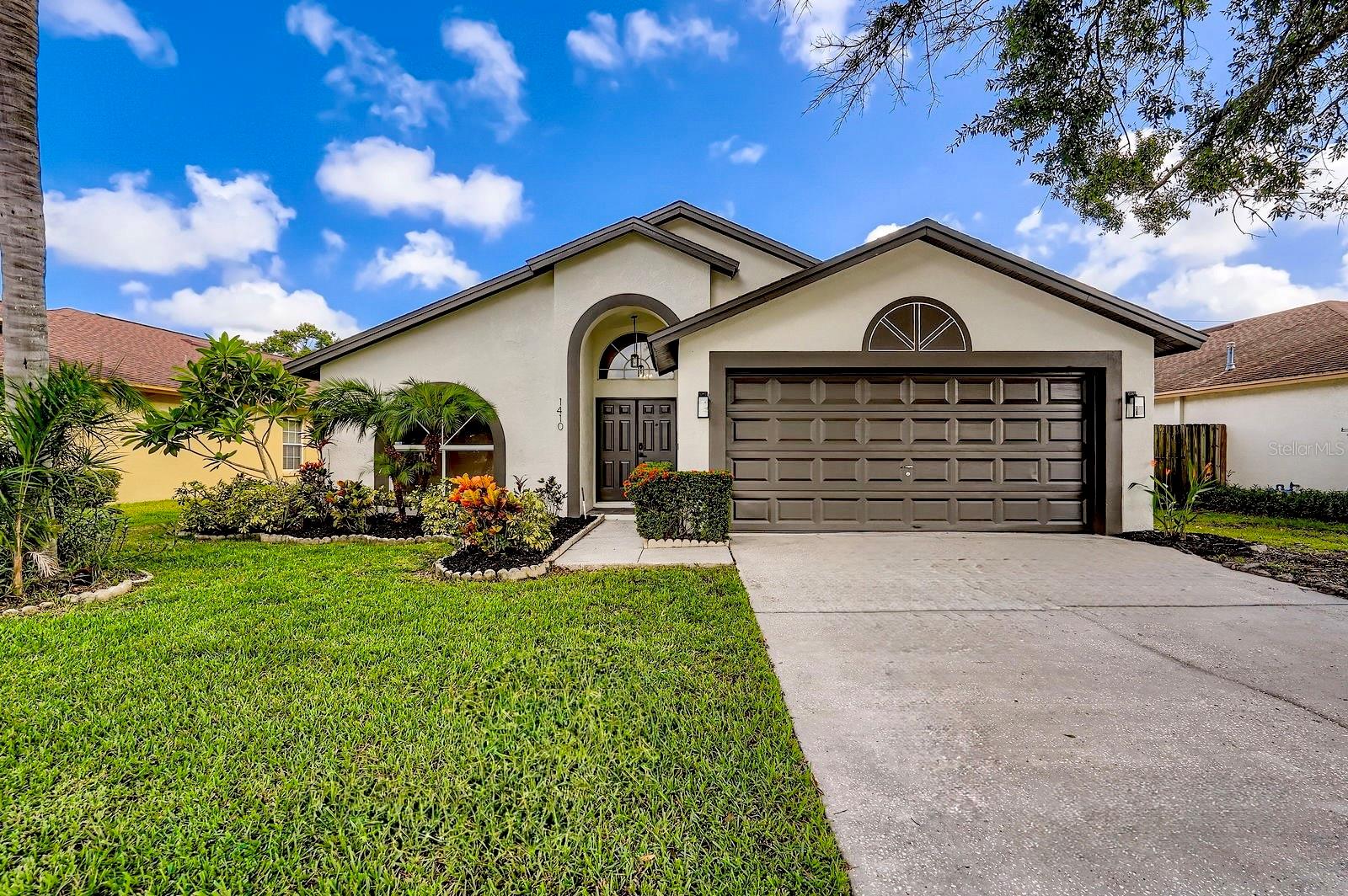 This move-in-ready home has been thoughtfully renovated from top to bottom. Freshly painted inside and out, it features new luxury vinyl plank flooring throughout and soaring vaulted ceilings that create a bright, open atmosphere. The brand-new kitchen boasts sleek quartz countertops, updated cabinetry, GE stainless steel appliances, a natural gas hookup, and modern fixtures—perfect for cooking and entertaining.  Both bathrooms have been tastefully remodeled with elegant tilework, stylish vanities, and designer finishes. A tankless water heater provides energy-efficient comfort, and every detail has been updated for modern living.  Enjoy Florida-style indoor-outdoor living in the oversized screened lanai, overlooking a fully fenced yard—ideal for pets, play, or peaceful relaxation.   Providence Lakes offers the perfect blend of convenience and tranquility set amongst lush landscaping and tranquil lakes.  Located just minutes from shopping, dining, and major freeways, this home combines style, comfort, and convenience in one beautifully updated package.