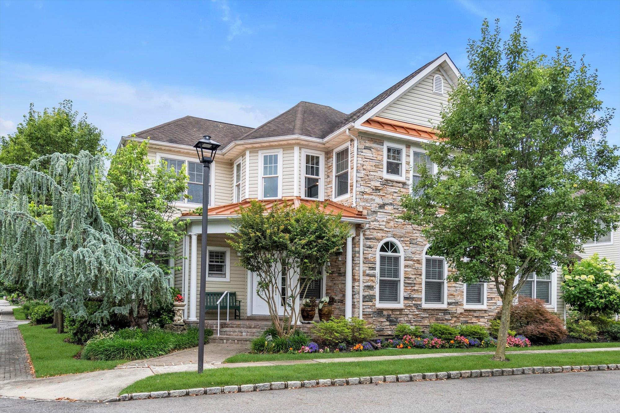 LUXURIOUS HARBOR VIEW CONDO HOUSE! Discover elegant living in this stunning HOME with the largest lush flower garden/patio nestled in the prestigious  upscale gated HARBOR VIEW community  of Port Washington. Enter and enjoy this light filled wonderfully designed and beautifully maintained home spanning over 3100 sqft of luxurious living options with its open floor plan, hi ceilings, crown moldings, surround sound, LED, and stunning  & practical wide plank Brazilian Black Walnut flooring.  Enjoy the convenience of a main level primary bedroom  wonderfully lit by it corner windows and two large walk-in closets ,  en-suite bathroom with  radiant heat floors, a Toto Washlet & over sized bathtub.  The first floor open layout offers several options for use.  The upstairs is airy with views of flowering trees; the loft offers options including a possible 4th bedroom.  The 2nd floor has two ample sized bedrooms each with its bathroom and walk-in closet; the large storage room is a wonderful asset in a condo.  Management is responsible for grounds year-round and offers the use of a full gym, exercise classes, sauna, Jacuzzi, card rooms, as well as indoor and outdoor pools. Situated just steps from Harbor Links Golf Course, this home offers scenic views and easy access to recreational activities, including walking trails, Bar Beach, park and nearby shopping. Easy Access to Major Highways. This home is a rare find in a sought-after location of 55+ with a blend of  luxury and convenience.