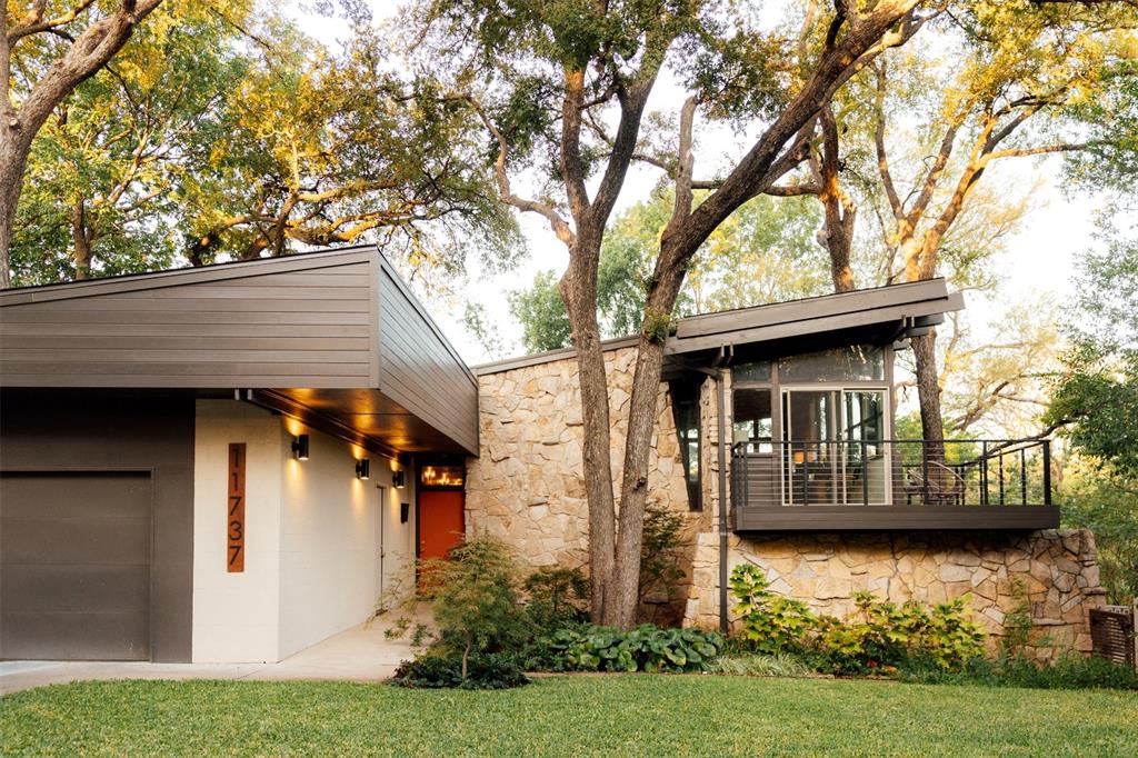 Welcome home to Lochwood and treehouse living. Designed and built by celebrated Dallas architect Donald Speck as his personal residence in 1961, this mid-century modern, architecturally significant treasure features period details that have been preserved with intuitive updates. This home starred in a 1960s sci-fi film and was recently featured on the White Rock Home Tour. Thoughtfully restored in 2024, this is a rare chance to own a true piece of Dallas architectural history. Set across five levels on a .27 acre corner lot beside the protected Lippitt Branch greenbelt, the home lives like a treehouse. Walls of panoramic windows, six sets of sliding glass doors and two creek-facing balconies bring the canopy inside, and the soundtrack is birdsong, just minutes from White Rock Lake. Speck's signature details remain the star: exposed ceiling beams, a sloped roofline, soaring stone walls and open-tread staircases with cable railings that connect each level. The restoration layers in bold personality with a 3D 1960s cinderblock feature wall in warm orange, sculptural hex tile, custom walnut-tone cabinetry, quartz counters, brass fixtures and a GE Cafe appliance suite in white and gold. The primary suite opens to a private patio and features a spa-worthy bath wrapped in deep blue hex tile. The 2024 restoration took much of the home to the studs with a focus on comfort and efficiency: lifetime shingle roof with radiant barrier decking and a 5 year workmanship guarantee, closed-cell spray foam insulation in the roof and exterior walls, Jeld-Wen low-E windows and exterior doors, two Carrier 15 SEER systems, new electrical wiring, 150 amp panel, 50 gallon gas water heater, level 5 drywall, Hardie siding and trim, custom 34 inch front door, new decks and railings, sprinkler system, French drain and an 8 ft cedar fence. Three bedrooms, two baths and 2,226 sf of history, craftsmanship and treetop views. Homes like this rarely come along.