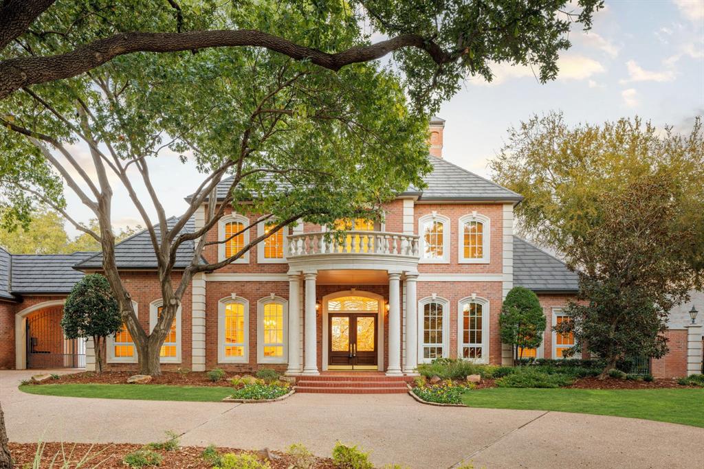 Tucked away on a quiet cul-de-sac surrounded by lush, mature trees, this breathtaking traditional estate offers more than 9,000 square feet of refined living overlooking the 12th fairway of the Gleneagles Queen’s Course. A circle drive, grand double-leaded glass doors, and manicured landscaping set the stage for the sophistication within. Inside, the home impresses with soaring ceilings, marble floors, and intricate crown molding. Sunlight floods through expansive windows framing sweeping views of the pool, creek, and rolling hills beyond. A dramatic curved staircase greets guests in the foyer, while the formal living and dining spaces are complemented by a butler’s pantry with built-ins—perfect for entertaining in style. The den, featuring a stately wood coffered ceiling and wet bar, looks out to tranquil golf course views. A game room with a second wet bar offers the ideal space for relaxed gatherings. The gourmet kitchen is a true centerpiece with Thermador and GE Profile appliances, a massive island, a FiveStar commercial-grade 6-burner cooktop, double ovens and dishwashers, and new custom cabinetry throughout. The primary suite provides a sanctuary of luxury with a sitting area overlooking the greens, a cedar closet, and a spa-like bath with a freestanding tub, marble shower, dual vanities and toilets, and a bidet. An upstairs secondary suite includes one ideal for a secondary study and a second primary in-law suite with a balcony and fireplace. Beyond the interiors, enjoy a resort-style outdoor experience with an expansive pool deck, lush play yard, and full pool bath. Thoughtful details abound, from two front and two rear gated porte cocheres to a potting room workshop off the garage and a back staircase for convenience. An extraordinary blend of craftsmanship, comfort, and setting—this estate captures the essence of luxury golf course living in one of North Texas’s most prestigious communities.