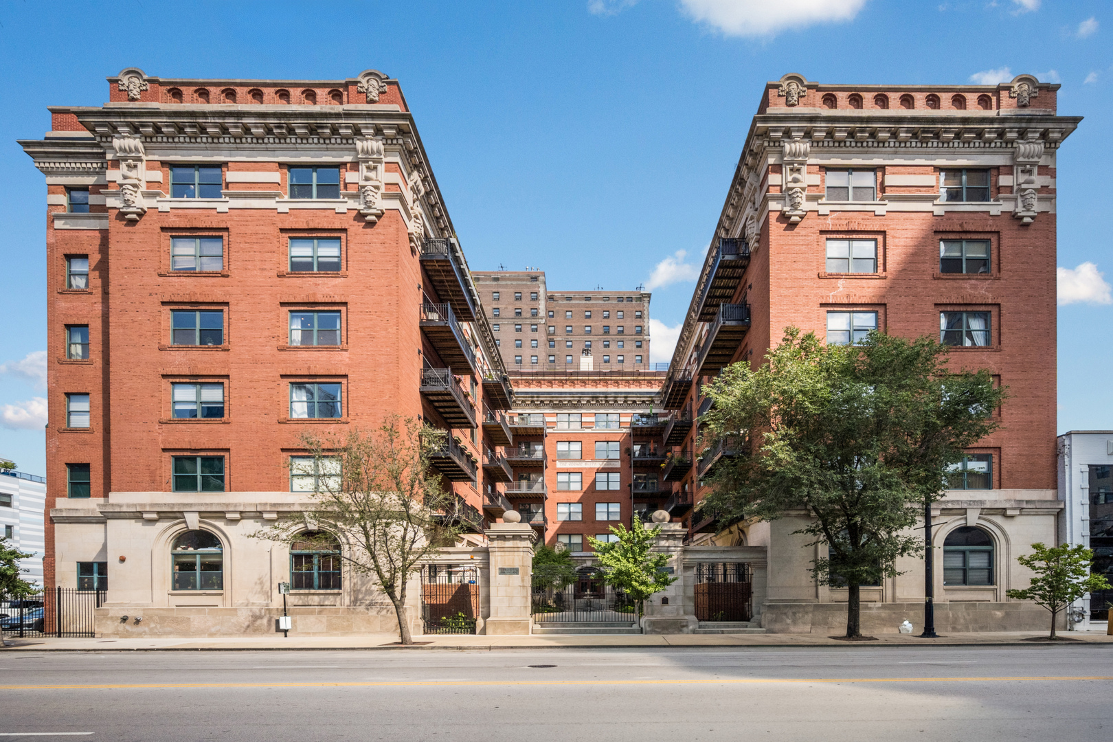 Looking for a contemporary, light-filled home with character and  convenience? This rarely-available, 2 bedroom, 2 bath, 1,200 square  foot corner unit at landmarked Trevi Square Lofts checks every box.  Located in a building on the National Register of Historic Places,  this home effortlessly combines the charm of historic architecture and  the open ease of modern living. Soaring 11-foot ceilings, exposed  brick walls, hardwood floors, open floorplan kitchen, in-unit  washer/dryer, and a spacious living/dining room centered on a cozy  wood-burning fireplace. Living space extends onto a large, private  balcony overlooking a manicured courtyard with a fountain. Indoor  elegance effortlessly transforms into a large outdoor sanctuary,  perfect for entertaining in a few easy steps.   Living area features  large work from home built in.   The huge ensuite master bedroom and  spacious second bedroom (that can easily double as a home office or  nursery) offer tons of closet/storage space and even a Murphy Bed. A second bath next to  the foyer creates a dedicated entry that is welcoming and accessible.  One gated secured outdoor space is included.  Lot has electric vehicle charger available for residents.  Storage locker in basement and bike room storage included.   This great South Loop  location is close to dining, shopping, lake / lakefront, CTA,  Soldier Field, Grant / Millennium Park.