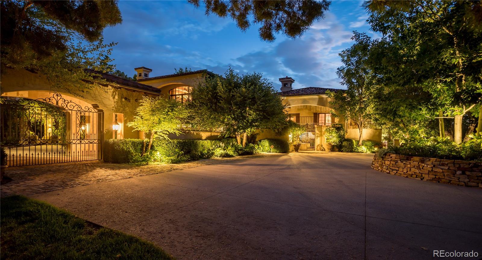 At the end of a private lane and backing to serene Little Dry Creek, this extraordinary estate spans 2 acres of park-like grounds. Gated circular drive & elegant porte-cochère set the tone, welcoming you to a European-inspired residence where timeless architecture meets exceptional craftsmanship & bespoke detail—all framed by breathtaking natural surroundings. Inside, a dramatic entry reveals beautifully curated living & dining rooms that open to a balcony overlooking the stunning backyard. Reclaimed hardwood floors, hand-plastered walls, intricate wrought iron, custom-carved European stone fireplaces and exquisite lighting create warmth & character. Chef’s kitchen blends artistry with function, highlighted by hand-painted tile signed by artist, Scott Yablonski. Sunlit primary suite is a luxurious sanctuary, with private patio, spa-inspired 6pc bath, huge walk-in closets and adjacent guest en suite. Expansive lower level offers 2 en suites, family & game room, wine room, study, gym, laundry & abundant storage. Striking stone staircase leads to a secluded upper-level suite with a 4pc bath, coffee bar & private patio perched above the courtyard. Outdoor spaces are nothing short of spectacular. Multiple patios create inviting destinations for gathering, including a showstopping terrace with outdoor fireplace and vine-draped arbor made for unforgettable al fresco dinners. Spend afternoons at the bocce ball court, unwind beside the picturesque pond at sunset, or retreat to the charming “Martha Stewart” potting shed. Car enthusiasts will appreciate 4 garages with new epoxy flooring + snow-melt systems at the car court, courtyard & north walkway. Above the 650 sqft garage a versatile attic flex space offers endless possibilities. Both a private sanctuary and an entertainer’s dream—equally suited for intimate evenings or grand celebrations. One of the most coveted settings in Old Cherry Hills, offering a rare blend of seclusion & convenient access to nearby amenities.