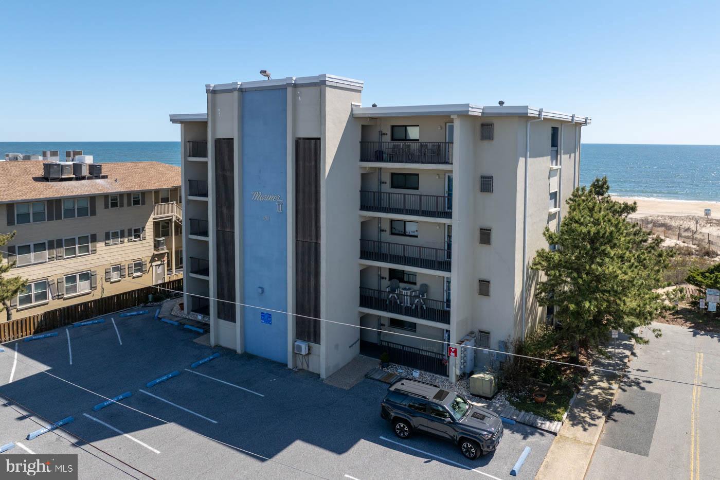 Direct oceanfront at Mariner II with a covered walk-off balcony and a private sand path through the dunes — step off the balcony, take a few steps, and you are on the beach. No shared elevator or interior stairs between the unit and the sand.Offered fully furnished and turnkey. No prior rental history — owner-used only — and ready to step into rental rotation if that is the plan.Interior is fully updated. Living and dining are open to each other and to the kitchen, with a full shiplap wall behind the sofa. White kitchen has stone counters, subway tile backsplash, and a peninsula bar. Light flooring runs through the main living areas. Wide sliders frame the dune view and pull natural light deep into the room.Primary suite features a king bed and a fully updated ensuite — vertical-tile walk-in shower with glass enclosure, custom built-in niches, wood-look vanity with quartz top, and matte black framed mirror. Dune views from the bedroom window.Second bedroom is configured with two queens — sleeps four in that room. Room for the entire family and friends!Second full bathroom with tub-shower combination serves the guest bedroom and main living spaces.Covered balcony with seating overlooks the dunes and beach. Assigned parking space plus unassigned overflow. Outside Shower as well!Move-in ready. Use as a primary residence, second home, or rental property.