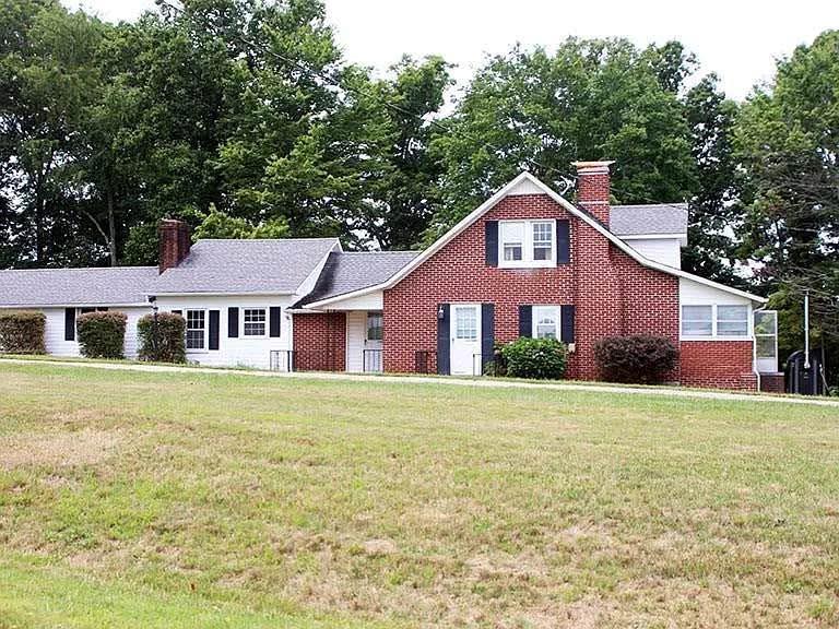 Beautiful brick home on 2.92 country acres. Charming and spacious, 3 bedroom 1 bath with 2040 sq. ft. of living area. Located in a quiet, unrestricted area of the county that is convenient to Stuart and Mt Airy NC. There are replacement windows, hardwood floors and 2 fireplaces. The family room opens up to a patio that overlooks a tranquil, private yard with mature trees, mountain views and the neighbor's large pond. A gorgeous new tile floor and up-styled fireplace  in the family room  A large eat in kitchen has plenty of cabinetry, refrigerator, electric range and dishwasher. The principal bedroom is on the main level along with laundry and a full bath with 2 additional bedrooms on the upper level.