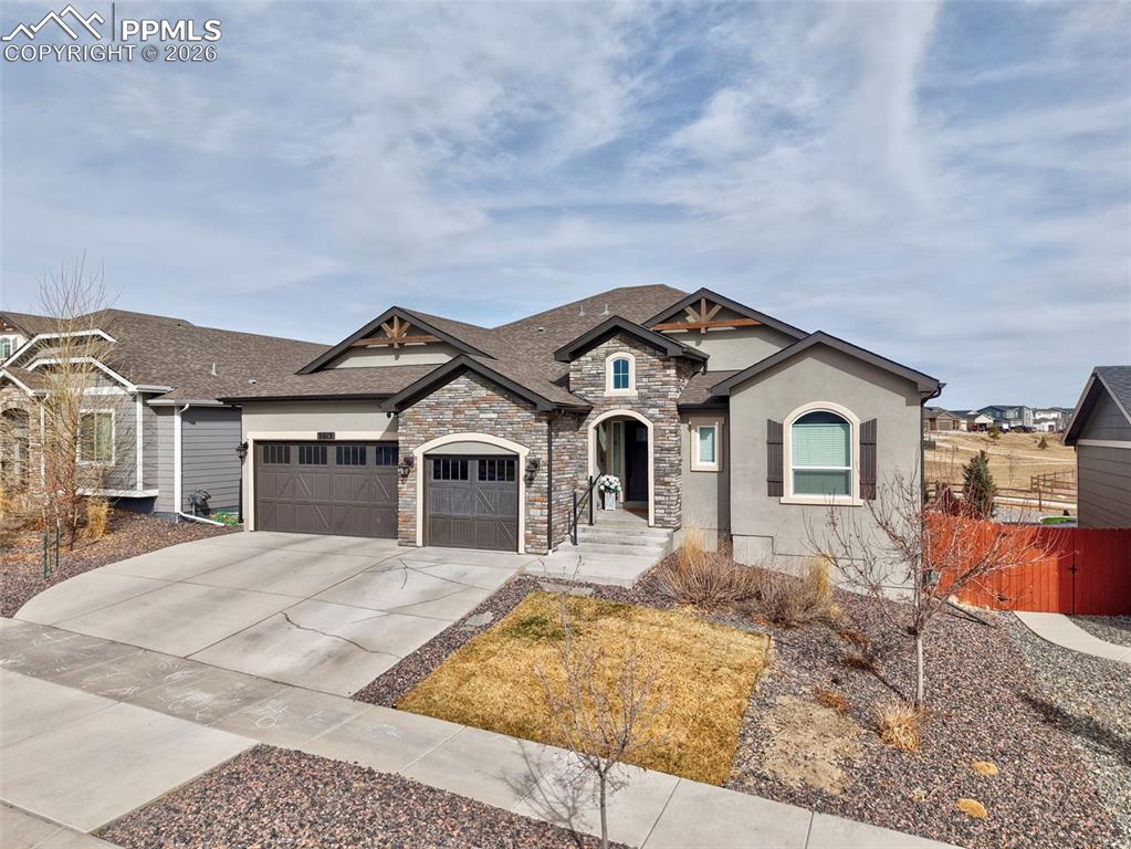 Looking for a 5 bedroom home backing to open space with no rear neighbors, a finished garden level basement, smart home upgrades, and high end finishes in the sought after Meridian Ranch community in Peyton, Colorado? This Saint Aubyn Presidential home blends Colorado inspired architecture with built in entertainment. Stucco with stone accents, 3 car garage with raised panel carriage style doors. Inside has upgraded interior featuring LVP flooring in the main living areas, rounded drywall corners, 4.5 inch baseboards, decorative arches and niches, iron spindle railing, and a stone accented fireplace with a flat wall above it ready for your mounted TV. The gourmet kitchen offers quartz slab countertops, 42 inch birch cabinets with crown molding, stainless Whirlpool appliances including a gas range, wall oven and microwave, full range hood, and oil rubbed bronze fixtures. The home also features a formal dining space that can easily be used as an office or flex room. The primary suite offers large windows for natural light and a spacious ensuite bath with dual sinks, soaking tub, stand up shower, and beautiful tile finishes. Throughout the home you will find recessed lighting, custom paint accents, and vaulted ceilings that enhance the open feel. The basement brings in abundant natural light and features a large entertainment space with built in surround sound plus additional hard wired speakers throughout the home including the wet bar, kitchen, primary bedroom, and covered patio, all controlled through the Nuvo app. Enjoy Colorado outdoor living and entertaining on the 26 x 12 covered patio deck with built in speakers, a gas line for BBQ, and a putting green while backing to open space on a large lot. Extras include electrical blinds in the upper living room windows, hard wired Ring floodlight security cameras, double pane Low E vinyl windows, a 93 percent efficient gas furnace, central air conditioning, humidifier, 50 gallon hot water heater, and a drywalled garage.