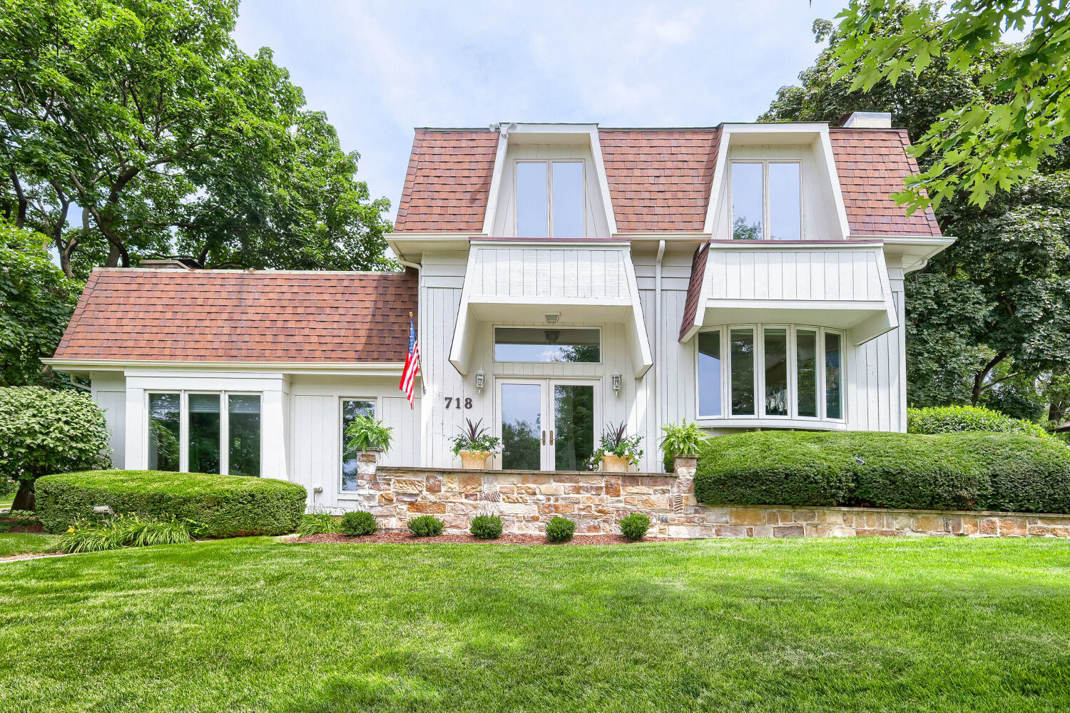 Prime location-rarely available! Nestled directly across from Pottawatomie Park and the Fox River in one of St. Charles' most sought-after historic neighborhoods, this exceptional home offers an unmatched lifestyle. Enjoy the convenience of strolling to vibrant downtown St. Charles, where charming cafes, restaurants, parks, the library, boutique shopping, and year-round community events are just moments away. This contemporary, beautifully updated home features 3 bedrooms, 2 1/2 baths, and thoughtfully designed living spaces filled with natural light. The spectacular family room is the heart of the home, showcasing a soaring vaulted ceiling, dramatic stone-hearth fireplace, and walls of windows that frame picturesque views while bringing the outdoors in. The updated kitchen is appointed with custom cabinetry, stainless steel appliances, and a charming bay window, flowing seamlessly into the elegant formal living and dining rooms-ideal for everyday living and entertaining alike. Additional highlights include an attached 2-car garage with a convenient mudroom and a private outdoor oasis featuring expansive paver patios, mature trees, and lush landscaping that create the perfect setting for relaxing or hosting guests. A rare opportunity to own a home that combines scenic beauty, timeless charm, and an unbeatable walkable location in the heart of St. Charles. Lifestyle living at its finest.