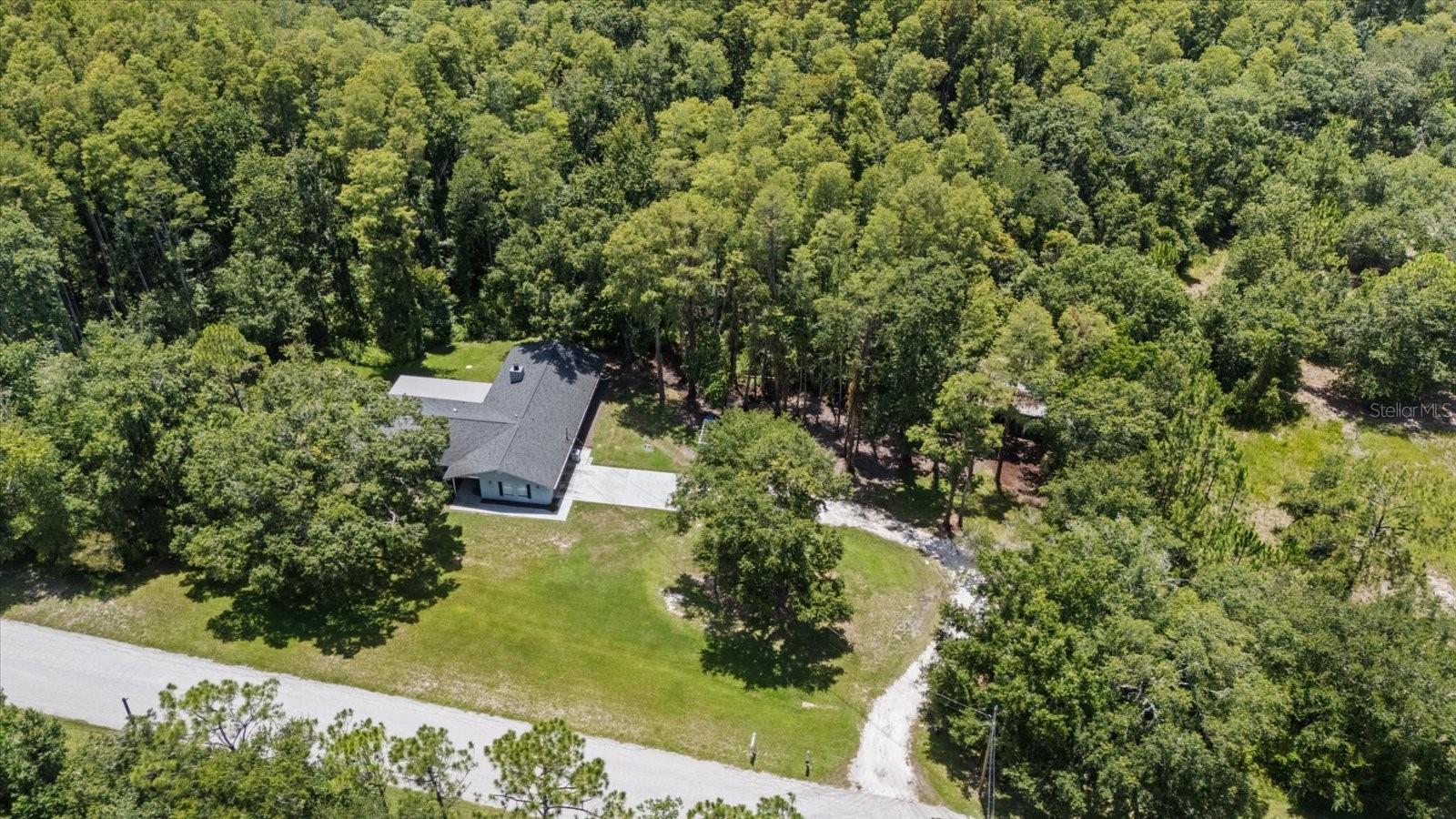 Escape the ordinary without sacrificing convenience! Welcome to 346 Ranch Road, a private 5.69-acre retreat in the highly desirable Keystone Ranchettes where peaceful country living meets the Florida's Gulf Coast lifestyle. Situated among some of Keystone Ranchettes' most impressive estate homes, with most neighboring properties valued at over $1 million. Professionally decorated and thoughtfully refreshed, this property offers buyers a fresh new look with additional land clearing that showcases more of the usable homesite while preserving the beauty and privacy of the surrounding woods.Whether you're searching for a family estate, horse property, private homestead, multigenerational living, or an income-producing investment, this one-of-a-kind property offers endless possibilities.This tastefully updated 4-bedroom, 3-bath home features spacious living areas, an open floor plan, a wood-burning fireplace, quartz countertops, shaker cabinetry, stainless steel appliances, and an oversized 2-car garage. The primary suite opens to the covered patio, creating the perfect place to enjoy peaceful mornings overlooking your private outdoor sanctuary.Outside, the opportunities continue. The existing 4-stall stable is ideal for horses or could be transformed into a workshop, hobby space, or future barn with guest quarters or an apartment (subject to county approval). There's plenty of room for a pool, RV, boat, trailers, and all your recreational toys.Approximately 1.3 acres are buildable, providing generous space for outdoor living and future improvements, while the remaining wooded acreage creates your own private nature preserve. Deer and other native wildlife are frequent visitors, while the wooded acreage offers the perfect setting for walking trails, ATV adventures, dirt bikes, or simply enjoying the peace and privacy that make this property so special. A picturesque seasonal creek meanders along the southern edge of the property, adding character, natural beauty, and an additional layer of privacy to this peaceful natural setting.Located in unincorporated Pinellas County, short-term rentals are permitted, making this an exceptional opportunity for Airbnb, vacation rental, or multigenerational living.One of this property's greatest surprises is its location. Although it feels miles away from everything, you're only about 15 minutes from Fred Howard Park, Sunset Beach, and the historic Tarpon Springs Sponge Docks; approximately 20 minutes to Downtown Dunedin; about 30 minutes to Clearwater Beach; and roughly 35 minutes to both Tampa International Airport and St. Pete-Clearwater International Airport. Shopping, dining, golf, parks, medical facilities, and top-rated schools are all nearby.For added peace of mind, the home previously experienced soil settlement at the rear of the property. The foundation has since been professionally reinforced and stabilized by a licensed foundation repair contractor, and the repair includes a transferable lifetime warranty.Properties offering this combination of acreage, privacy, flexibility, investment potential, and proximity to Florida's Gulf Coast are becoming increasingly rare. Whether you envision a private family retreat, an equestrian lifestyle, a weekend getaway, or a high-demand short-term rental, this exceptional property offers the freedom to make it your own.