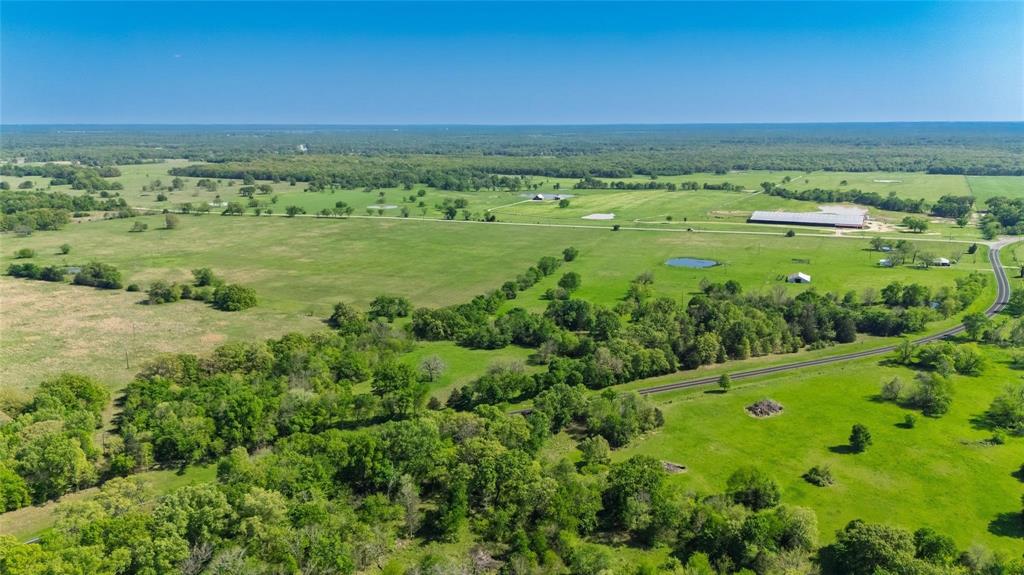 Enjoy the legacy and history of this property that has been part of a family since the Civil War! Discover a rare opportunity to own a beautiful 156 acres in Hopkins County on a corner tract with lots of road frontage and a brick farmhouse. With a mixture of pasture and woods, you have places for cattle to graze and for hunting habitats. A well-maintained milking parlor and pole barn with working pens give you options for storage or other use. And no worries--there are NO solar or lithium leases. Some old-growth timber can be found, some frontage on Wolf Pen Creek. For sports enthusiasts, an abundance of deer roam the property. For the rancher, level fields of native grass, 6 ponds, and good fencing with cross fencing provides plenty of support for livestock. Owner will retain 50% of the mineral estate. Inside the solid brick farmhouse, you can spread out with 2 living areas. Or make the oversized family room, with half bath and access to front and back of house, a third bedroom. Lots of cabinets, electric cooktop, and wall oven, come with the u-shaped kitchen that has room for an eat-in area. A separate dining area is connected to the front living room. You'll appreciate the crisp-white walls that brighten up the interior space. Plus you have an attached carport and a storage building near the house. Take advantage of the boundless options of this amazing ranch at the corner of two FM highways!