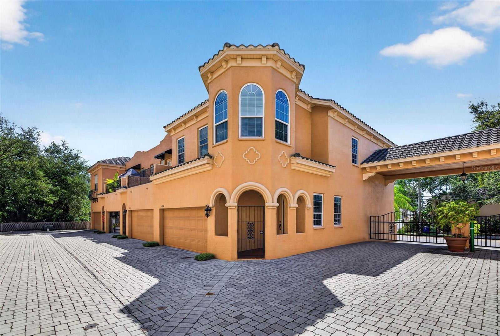 Rare Find! Just a 3-minute walk to Bayshore Boulevard! Welcome to this beautifully updated Mediterranean-style townhome in the heart of South Tampa’s highly sought-after Bayshore Beautiful neighborhood. This exceptional corner-unit residence combines an incredible location with timeless Mediterranean-inspired architecture, privacy, spacious living, and thoughtful upgrades, including upgraded hurricane-impact windows and professionally installed ceiling speakers throughout the home. Behind the secure gated entrance, this two-story concrete townhome welcomes you with tall doors, tall ceilings, rich wood flooring, and elegant crown molding. The open floor plan creates an inviting flow between the kitchen, dining, and living spaces, making the home equally suited for comfortable everyday living and entertaining. The spacious kitchen features granite countertops, solid wood cabinetry, stainless steel appliances, a gas range, breakfast bar, and adjoining eat-in area. The kitchen opens naturally to the generous living room, complete with a built-in entertainment center and beautiful gas fireplace. Large windows throughout the home fill the living spaces with natural light and create a bright, welcoming atmosphere. Upstairs, the oversized primary suite offers a private retreat with a spacious sitting area, luxurious en-suite bathroom featuring a soaking tub, and an expansive walk-in closet. Three large windows provide the primary bedroom with incredible natural light, creating a bright and peaceful setting throughout the day. Two additional bedrooms with flexibility for guests, family, or a home office, while the spacious loft provides even more versatility for an office, media room, or additional living space. A convenient laundry room with sink and ample storage completes the second floor. Step outside to your private paver patio and deck, perfect for morning coffee, outdoor dining, or relaxing with guests. As a corner unit within a gated community, the home offers a desirable sense of privacy and separation. The professionally installed structured/Cat 5 wiring and ceiling speakers throughout provide an integrated audio experience throughout the residence, making it ideal for entertaining or enjoying music throughout the home. Additional highlights include an attached two-car garage, private driveway, central HVAC, natural gas, and a 2023 water heater. Roof is maintained by the HOA. Enjoy an exceptional South Tampa lifestyle with Bayshore Boulevard just a short walk away. With its Mediterranean character, corner-unit privacy, hurricane-impact windows, whole-home speaker system, generous living spaces, abundant natural light, and two-car garage, this home offers a rare opportunity to experience the best of Bayshore-area living in a gated community. Close to Bayshore Blvd, Ballast Point Park, and Tampa Yacht & Country Club.