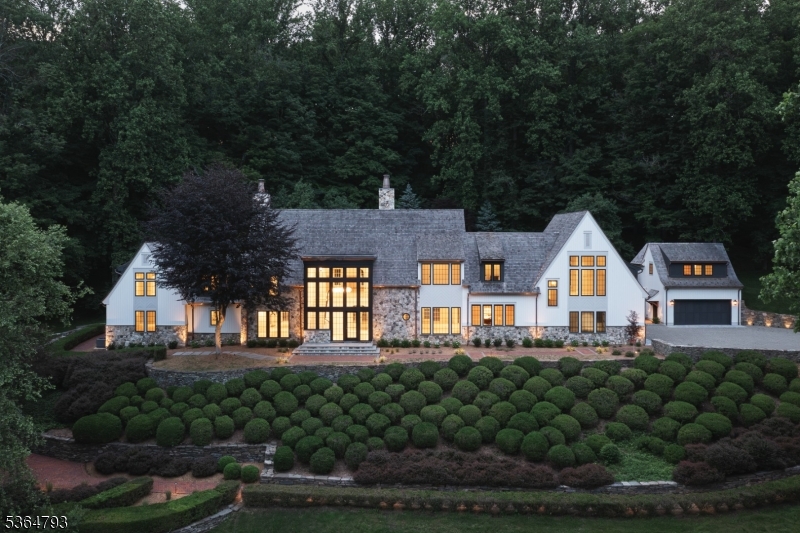 An unprecedented offering has come, representing new style and vision to historic Bernardsville Mountain. For the first time, the work of a noted NYC developer has arrived in NJ. With past achievements including NYC and international projects, luxury commercial properties, plus A-List Manhattan residences, his incomparable work has come to the Somerset Hills. Soaring ceilings, oversized windows framing countryside views, European white oak wood floors, wood-paneled and arched doorways, uncommonly beautiful bespoke cabinetry, and built-ins are among the defining statements of the interior finishes. Carefully designed for a blend of private living and exceptional entertaining, gathering spaces exist on all three levels and extend to the impeccable grounds. Every option, including single floor living is offered, with primary suites on the first and second floors. A jaw-dropping 20-ft atrium, two great rooms, an incomparable country sheik kitchen with adjoining butler's pantry, as well as a ground-floor wine cellar grace the inside. With views of the Somerset Hills, this 12-acre estate commands its ground and complements its surroundings. Extensive natural woods provide outstanding privacy and thoughtfully landscaped gardens, multiple patios, a pond, and country brick and stonewall walking paths encompass the exquisite property. A carriage house provides additional garage space for car enthusiasts and private living quarters above. This noteworthy offering is not to be missed.