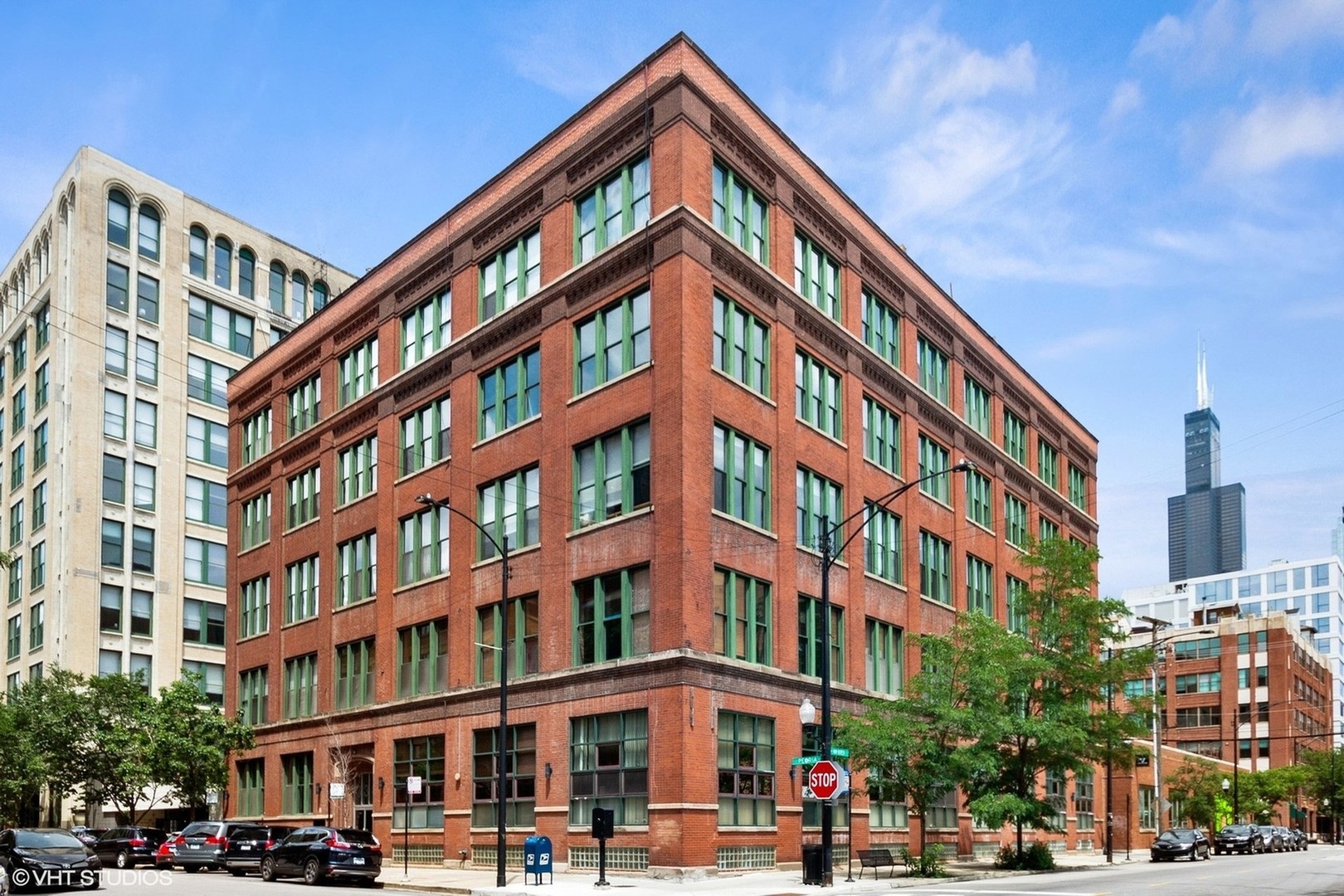 West Loop Penthouse Perfection!    This massive 2,000 sq ft 3BR /2.5BA duplex penthouse loft stuns with soaring timber ceilings, exposed brick, and dramatic walls of windows on two sides.   The sun-soaked living room features a showstopping fireplace with a live-edge mantel, while the sleek walnut kitchen boasts quartz counters, stainless appliances, and a breakfast bar.   Two oversized, FULLY ENCLOSED bedrooms (one is en suite) feature organized walk-in closets, walls of south- facing windows and luxe, updated baths with heated floors.   Upstairs, a 28'x28' flex space is large enough create a large family room, an office, a 3rd bedroom AND an exercise area too! This fantastic space is book- ended by walls of windows and opens to a private 28'x17' rooftop terrace with skyline views-perfect for entertaining, working, or working out. A half bath on the 2nd floor adds convenience. Check the photos for renderings showing potential for an easy 3rd bedroom build- out while still maintaining a multi- functional space.   All this in a boutique elevator building in a prime location, just steps to the best shopping, dining & nightlife the West Loop has to offer, as well as UIC, the Blue Line, and expressways. No parking on site, but multiple rental parking options are available, nearby, including next door. A rare find!