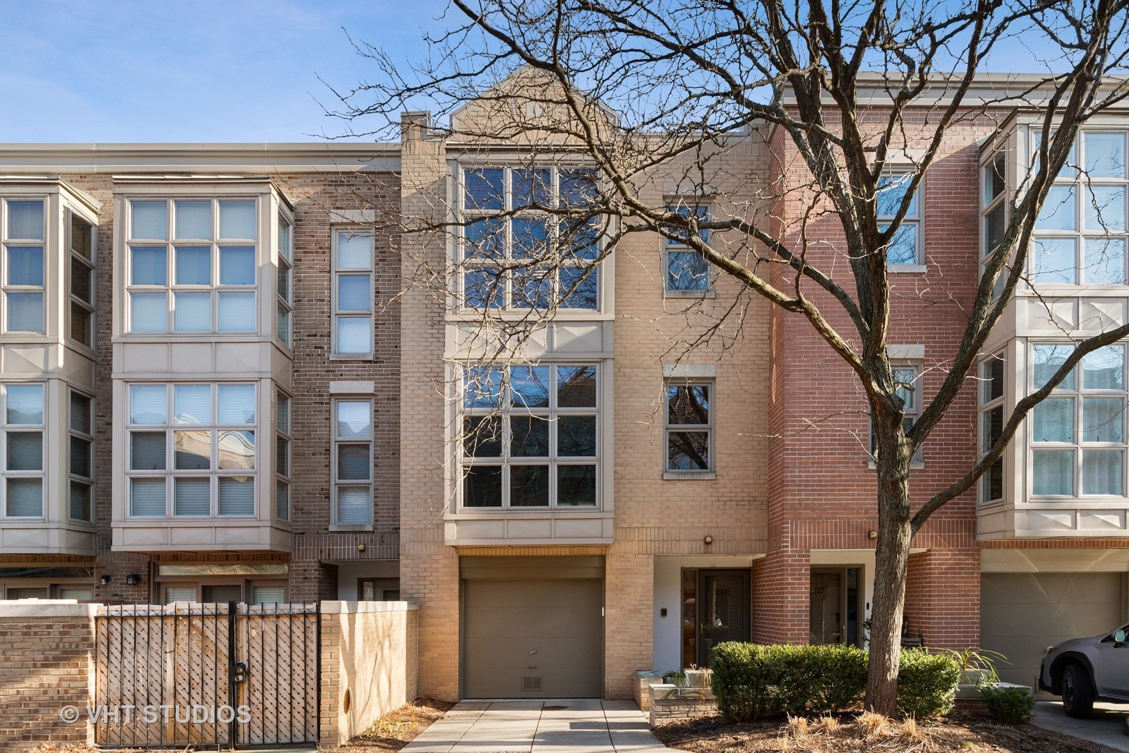 Tucked within one of Lincoln Park's sought-after gated communities, this beautifully updated three-bedroom townhome delivers the space, privacy and outdoor living that are so difficult to find in the neighborhood. With a flexible multi-level floor plan, two private outdoor spaces, attached garage and additional parking pad, this home lives more like a single-family residence. Enter through the first-floor family room, where a wall of windows and French doors open directly to a covered brick-paver patio-an ideal extension of the living space for entertaining or relaxing outdoors. One level above, the heart of the home unfolds with an oversized living and dining area centered around a fireplace with custom built-ins. The spacious white kitchen features granite countertops, breakfast bar, pantry, room for a full-size table and convenient laundry, while another set of French doors leads to a private deck with a built-in gas grill. The entire upper level is dedicated to the home's three bedrooms. The primary suite offers both walk-in and reach-in closets along with a completely renovated private bath. The second full bath has also been completely renovated, giving both upstairs bathrooms a fresh, beautifully updated feel. These improvements are just part of the extensive updating and care found throughout the home. Natural light is exceptional, enhanced by western exposure, expansive windows and a skylight above. Hardwood floors, fresh paint, excellent storage and generous room sizes add to the home's appeal. All of this within a secure, beautifully maintained gated setting offering private community gathering and recreation space, yet just minutes from everything that makes Lincoln Park so desirable-shopping, dining, transportation, Oscar Mayer Magnet School and Lincoln Park High School. A rare opportunity for space, privacy and move-in-ready living in an outstanding location.
