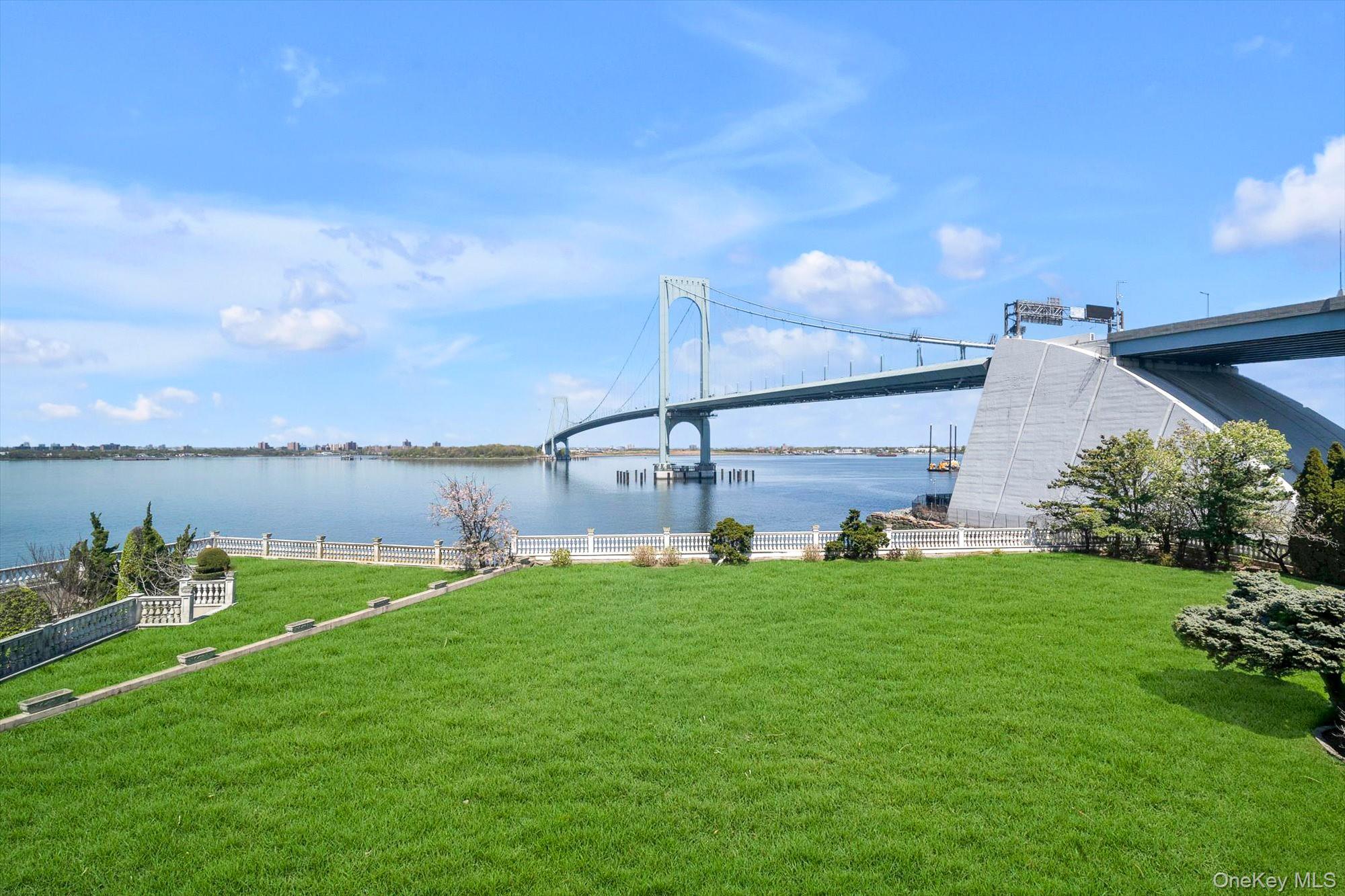 Set on a half-acre with 128 feet of direct waterfront, this 6,500 sq ft residence offers panoramic water views and a solid structural foundation. Rebuilt in 1980 with concrete and block construction, the home features detailed millwork, Kentucky oak, and Carrara marble flooring—preserve its distinctive elements while making the rest your own private oasis. Nearly every room captures waterfront and bridge views,  where the water creates a sense of calm and fills the home with natural light.The main level features a gracious entry foyer with coat closet, Large EIK with center island, a formal dining room with custom built-ins and sliding doors to a waterfront patio, a formal living room with fireplace, a den, a sunken sitting room, a private office/bedroom, and powder room. The second level offers four spacious en-suite bedrooms, an additional full bathroom, and an impressive bonus room with soaring 25-foot ceilings. The third floor provides separate living quarters with private exterior access, and features two bedrooms, a full bathroom, a large living/game room, and multiple storage rooms—ideal for extended family or guests.The basement includes both a sauna and a steam room for a private, spa-like experience.A long and wide driveway leads to a six-car garage. Additional highlights include CAC, central vacuum, a large balcony, Romeo and Juliet balconies, Closets galore all cedar-lined, Sliding doors to back yard patio, remarkably low taxes and more.For boating enthusiasts, nearby dockage is available.