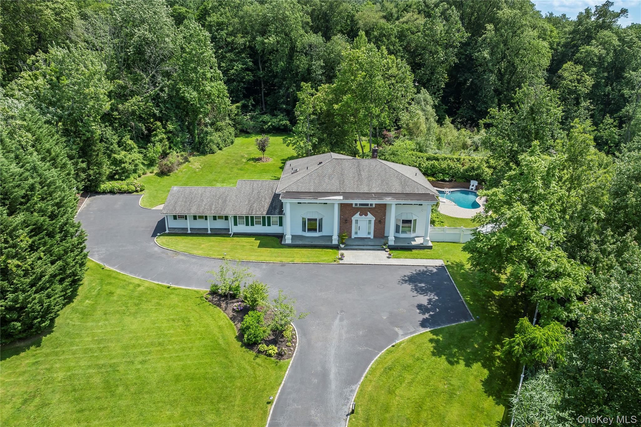 Welcome to 25 Montrose Court, nestled on 1.95 acres on a quiet cul-de-sac in Roslyn Harbor. This stately center-hall-colonial has been impeccably maintained with many upscale renovations and tasteful decor. Refined millwork and hardwood floors frame the spaces with traditional charm and warmth. The spacious first floor has grand principal rooms, providing many entertainment spaces. An oversized living room complete with a full wet bar accommodates large gatherings and opens into a cozy den with fireplace perfect for entertaining. The chef’s kitchen, complete with top-of-the-line stainless appliances, offers plentiful counterspace and a seated island, with generous custom cabinetry for storage and display. The striking dining room offers a beautiful view of the manicured, verdant grounds. A second den, bedroom, full bath, laundry room, pantry, and mud room complete the sprawling first floor.

The second floor hosts a large primary suite with wonderful natural light and space for a sitting area. Attached is an updated four-piece bathroom leading to an enviable walk-in closet/dressing room, a private gym and office. Three additional bedrooms and two full baths appointed with neutral colors complete the outsized second floor. A fully finished basement offers another large entertaining space with additional storage and a half bath. Full home generator.

The private, serene backyard is outlined by mature trees and landscaping, and offers outdoor leisure spaces including a saltwater pool, hot tub, TV lounge & built in barbecue. The property is zoned for a tennis court. 

Located in the desirable Roslyn School District, this home is easily accessible to New York City and awaits a buyer with vision and appreciation of fine architectural detail.
