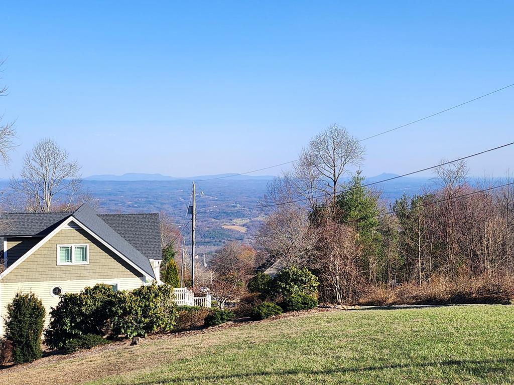 Beautiful Piedmont Views can be yours. View lots are getting harder to find. This lot is located just off the Blue Ridge Parkway in a wonderful community with many amenities and very reasonable HOA fees. Included are paved roads, a refreshing swimming pool to enjoy over the summer months, tennis & pickleball courts,, a shuffleboard court plus gazebo & clubhouse for community events, fishing ponds & picnic area. Come join in this golf cart friendly community's 4th of July golf cart parade. Chalet High is a hidden gem for mountain top living. Whether for a summer get away or year round living, Chalet High is a great place to be. Community water is available for a $650 connection fee. No expensive well to drill. This friendly community is only 6 minutes to Fancy Gap, 20 minutes to Hillsville or Galax and 25 minutes to (Mayberry) Mt. Airy, NC. Its very convenient to I-77. Lot will need to be perked for a septic system.