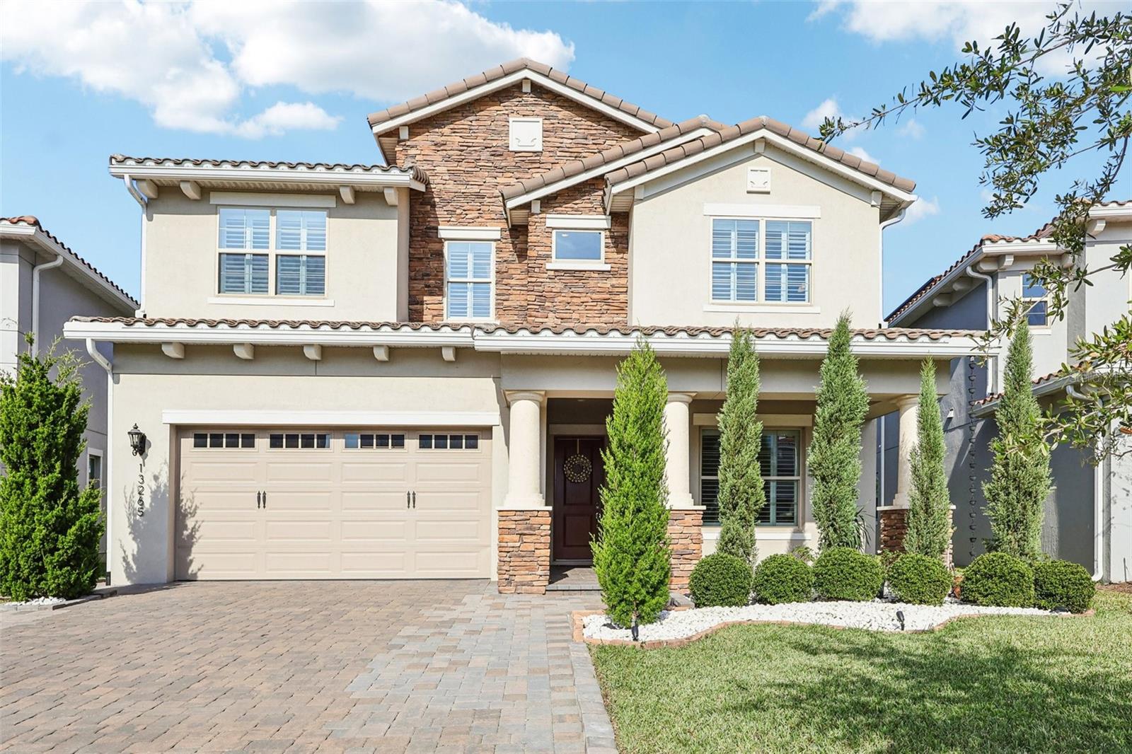 Waterfront Modern Masterpiece in Eagle Creek Golf Community - Welcome to 13265 Bromborough Dr – where contemporary luxury meets serene lakefront living in the prestigious Eagle Creek Golf Community. Built in 2023, this stunning 4-bedroom, 4-bathroom modern estate offers an impressive 4,287 square feet of climate-controlled living space designed for those who refuse to compromise.Step inside and be captivated by the sleek, modern design with tile flooring throughout – no carpet, just elegant, easy-to-maintain surfaces that complement the home's sophisticated aesthetic. Fresh interior paint creates a pristine canvas, while custom window shutters throughout add both style and light control. The walk-in closets feature premium cabinetry systems, maximizing storage with sophisticated organization solutions. The recently completed 480-square-foot addition transforms everyday living into resort-style entertainment, featuring an enclosed lanai with a second full kitchen perfect for hosting gatherings while soaking in breathtaking water views. The two-story layout maximizes the spectacular lakefront setting, with a massive balcony that serves as your private viewing platform to enjoy morning coffee or evening sunsets over the shimmering water. Outside, a beautifully pavered patio extends your living space, while newly installed sidewalks wrap around the home and an extended driveway provides ample parking and enhanced curb appeal. Entertainment reaches new heights in the expansive upstairs bonus room – your future media room, game room, or whatever your lifestyle demands. With four generously appointed bedrooms and four full bathrooms, there's abundant space for family, guests, and all of life's possibilities. Sustainable Living with Solar Advantage - Enjoy the benefits of a leased solar system that delivers near-zero monthly electric and water bills – and the lease includes maintenance coverage for complete peace of mind. Experience modern luxury with dramatically reduced utility costs while embracing sustainable, eco-friendly living. Life at Eagle Creek: Your Private Resort - Beyond your front door awaits a world-class community that rivals the finest resorts. Tee off at the Eagle Creek Golf Club and unwind afterward at the Belfry Restaurant and Bar in the stunning golf clubhouse. Stay active at the resident clubhouse featuring a state-of-the-art fitness center, multiple sparkling pools, tennis courts, and a basketball court. Your furry friends will love the dedicated dog park, while families appreciate having Eagle Creek Elementary School right in the community. With 24-hour guard-gated security, multiple parks throughout the neighborhood, and Eagle Creek Center offering convenient shopping, dining, and services just moments away, everything you need is at your fingertips. This is more than a home; it's a lifestyle statement in one of Orlando's most desirable golf communities, where modern elegance, waterfront tranquility, and sustainable living converge. Don't let this rare opportunity slip away. Contact us today to schedule your private showing and experience the magic of lakefront living at 13265 Bromborough Dr.