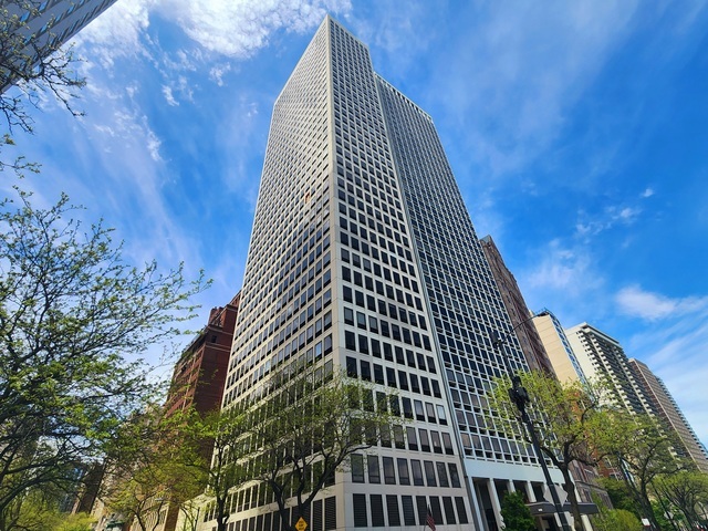 (Motivated Sellers) Chicago will never look -- or feel as good as it does from this 36th-floor urban retreat whose 17 windows celebrate Lake Michigan and the city's dazzling architecture. Fall in love with the beauty and serenity that envelop this luxurious two-bedroom plus family room (easily converted back to a third bedroom). Situated on Chicago's prestigious Lake Shore Drive, two blocks from Michigan Avenue in the heart of the historic Gold Coast, this sought-after corner unit has been meticulously and elegantly reconfigured to facilitate easier living. Enter through the gracious foyer that divides the living and sleeping areas. Windowed walls flood each room with natural light from eastern and southern exposures regulated via remote-controlled blinds. Updated on-trend parquet flooring and raised door frames throughout add to the home's stylishness. The spectacular one-of-a-kind chef's kitchen features a 10-ft stainless steel island and matching countertops complimented by Vallcucine Italian cabinetry and top-of-the-line appliances including a Miele refrigerator and built-in coffee maker, integrated Thermador wine refrigerator, Kuppersbusch cooktop and oven, Fisher & Paykel dishwasher and abundant cleverly concealed storage. The adjoining family room/den augments the kitchen's hospitality potential, creating a cozy and inviting space for gatherings and relaxing. The over-sized living room and dining area, ideal for entertaining with even a wet bar, invite you to enjoy their extensive double-exposure vistas. The crown molding's unique cove lighting that surrounds this area and its adjoining hallway and foyer give it added panache. Traverse the length of the cove-lit second hallway off the kitchen and you'll discover the large primary bedroom with double custom closets. An attached small hallway houses a massive, custom walk-in clothes closet and leads to the beautifully designed and enlarged ensuite bathroom with premium tiling and lighting, a free-standing soaking tub, dual-sink floating vanity and spa-like shower. A spacious second bedroom with room for a king-sized bed and additional furnishings also boasts a large custom closet. A handsome full bath with natural stone finishes and a large shower is conveniently located just across the hall. Closer to the foyer lies an attractive powder room with a similar stone motif and another huge walk-in closet with a Bosh washer/dryer and more storage. The unit does not share its elevator foyer with anyone else. Michael Jordan once called this modernist, intimate skyscraper home. Designed by Harry Weese, the Chicago architect who created dozens of iconic buildings and homes throughout the country and America's most beautiful metro in Washington, DC, it has always inspired a devoted following. Amenities include 24-hour door staff, on-site management, fitness room, and an almost completed remodeled hospitality room with full kitchen, a new guest suite that can be reserved for Building residents' guests, sun deck, attached valet parking for 250 a month, guest parking, storage and a bike room. The building's location also enjoys a Walker-Paradise designation and top scores for biking and transit. Imagine walking out your lobby door to a shimmering lake and Oak Street Beach beckoning you along with Rush Street restaurants, Michigan Avenue shopping, cultural and sports attractions, top-tier medical facilities and Lincoln Park. Tour this one now and experience living from a spectacular perspective.
