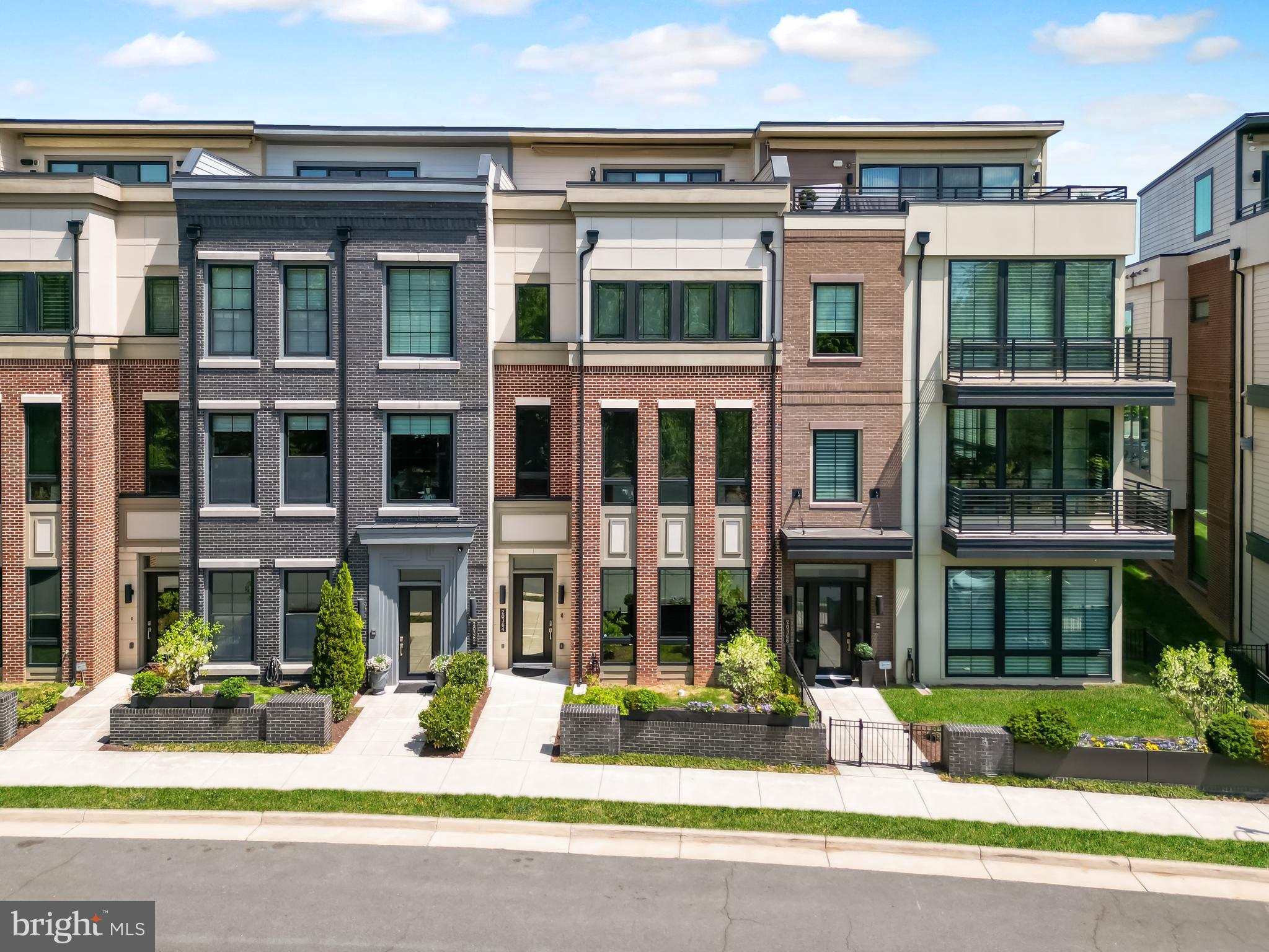 (More photos coming on 5/18, on the market on 5/22)  Experience the perfect balance of suburban and urban (Surban) living in the heart of One Loudoun with this unique, park-facing Miller & Smith townhome offering over 4,300 square feet across four impeccably designed levels.  This expansive residence features a private elevator, rooftop terrace, and unobstructed views of the community park, delivering the feel of a luxury single-family home with the convenience of a walkable, vibrant lifestyle. With 5 bedrooms, 4.5 upgraded baths, and multiple flexible living spaces, the home is ideal for multi-generational living, private home offices, fitness areas, or guest accommodations. Furthermore, One Loudoun offers resort like amenities as well as lawn care to bring even more convenience and elevated lifestyle.  The main living level showcases a sun-drenched open-concept design with soaring 10+ foot ceilings, wide-plank engineered hardwood floors, and seamless flow between the living, dining, and kitchen spaces. The chef’s kitchen is thoughtfully appointed with Wolf Professional appliances, a Sub-Zero refrigerator, quartz countertops, an expansive island perfect for entertaining, and a walk-in pantry with abundant storage. Step out to the private balcony for effortless indoor-outdoor living with gas line ready for grilling.The third-level has 10 foot ceiling, primary suite that offers tranquil, tree-lined park views and serves as a true retreat, complete with a spa-inspired bath featuring a soaking tub, oversized walk-in shower, and a custom walk-in closet. The hallway bathroom has two vanity with a tub and direct access from one of the two other bedrooms. The laundry room is conveniently located on this level with a linen closet, soaking tub and the washer and dryer that sits on a pedalstool for easy use.The fourth-level has a bedrooms, a generously sized walk in closet, full bathroom with shower, a loft area that can be used for gym, media, or recreation space that opens to the stunning rooftop terrace perfect for entertaining, grilling, or enjoying sunset views over Central Park. The terrace has gas line, hose, outlets ready for fire pit, gardening, and/or wall mounted TV. The entry level has 11 foot ceilings, access to front door, garage, mud room, coat closet, and a niche under the stairway for creative functionality. The large versatile room with double glass door is ideal for a bedroom, office, or flex space, along with a full bathroom with a bathtub. The elevator services all four floors. This home is ADA compliant and enhanced with smart home doorbell, door lock, thermostat, security, and whole-home connectivity options. Additional upgrades include Anderson black-framed windows, dual high-efficiency HVAC systems, and premium finishes throughout.Located just steps from One Loudoun’s renowned dining, shopping, entertainment, and community amenities including parks, trails, clubhouse, pool, and year-round events, this home offers a true live-work-play lifestyle in one of Northern Virginia’s most sought-after communities.