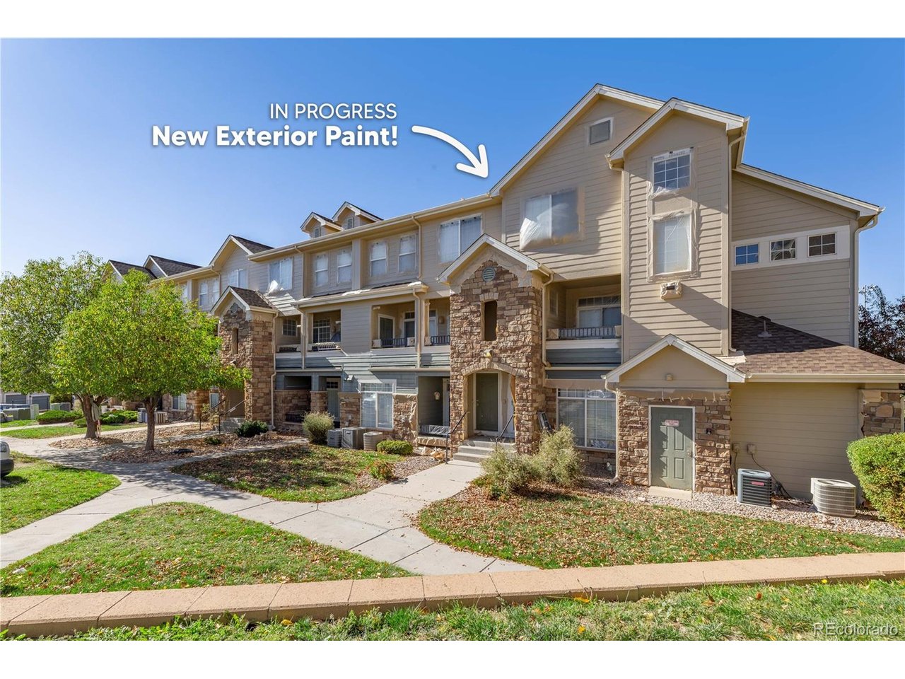 Updated over the last five years with a 2025 furnace, newer appliances, three new ceiling fans, new carpet, LVP flooring in the kitchen, new flooring in both bathrooms, and fresh interior paint, this two-bedroom, two-bathroom condo in Blackfeather has its major systems and finishes already taken care of, and the central air conditioner was installed in 2017. An entrance foyer leads into an open main level with high ceilings, where the eat-in kitchen has white cabinetry, a stainless steel sink, track lighting, a walk-in pantry, and bar seating that connects to a dining area with space for a full table. The kitchen comes with a range, refrigerator, dishwasher, and disposal. The living room has a gas fireplace and a sliding door to a covered patio with outdoor shades and a storage closet. Upstairs, the primary suite has a vaulted ceiling, a walk-in closet, and an en-suite bathroom with a double vanity and a tub/shower combo, and the second bedroom sits next to a full hall bathroom with its own tub/shower combo. Both bathrooms have newer sinks, toilets, and hardware. The laundry room is also on the upper level near both bedrooms, with built-in shelving and an included washer and dryer. Parking includes one space in a detached garage and one reserved surface space, and the building exterior is being freshly painted. The HOA dues cover insurance, exterior maintenance, grounds, snow removal, trash, recycling, water, and sewer, which keeps day-to-day ownership simple, and residents have access to the clubhouse, fitness center, pool, hot tub, and playground. The community sits along greenbelt open space with mountain views and is served by Douglas County School District schools. With the living spaces together on the main level and both bedrooms upstairs, the floor plan gives a clear separation between where you spend the day and where you sleep, and the updates already completed let the next owner focus on furnishing the home rather than replacing finishes.
