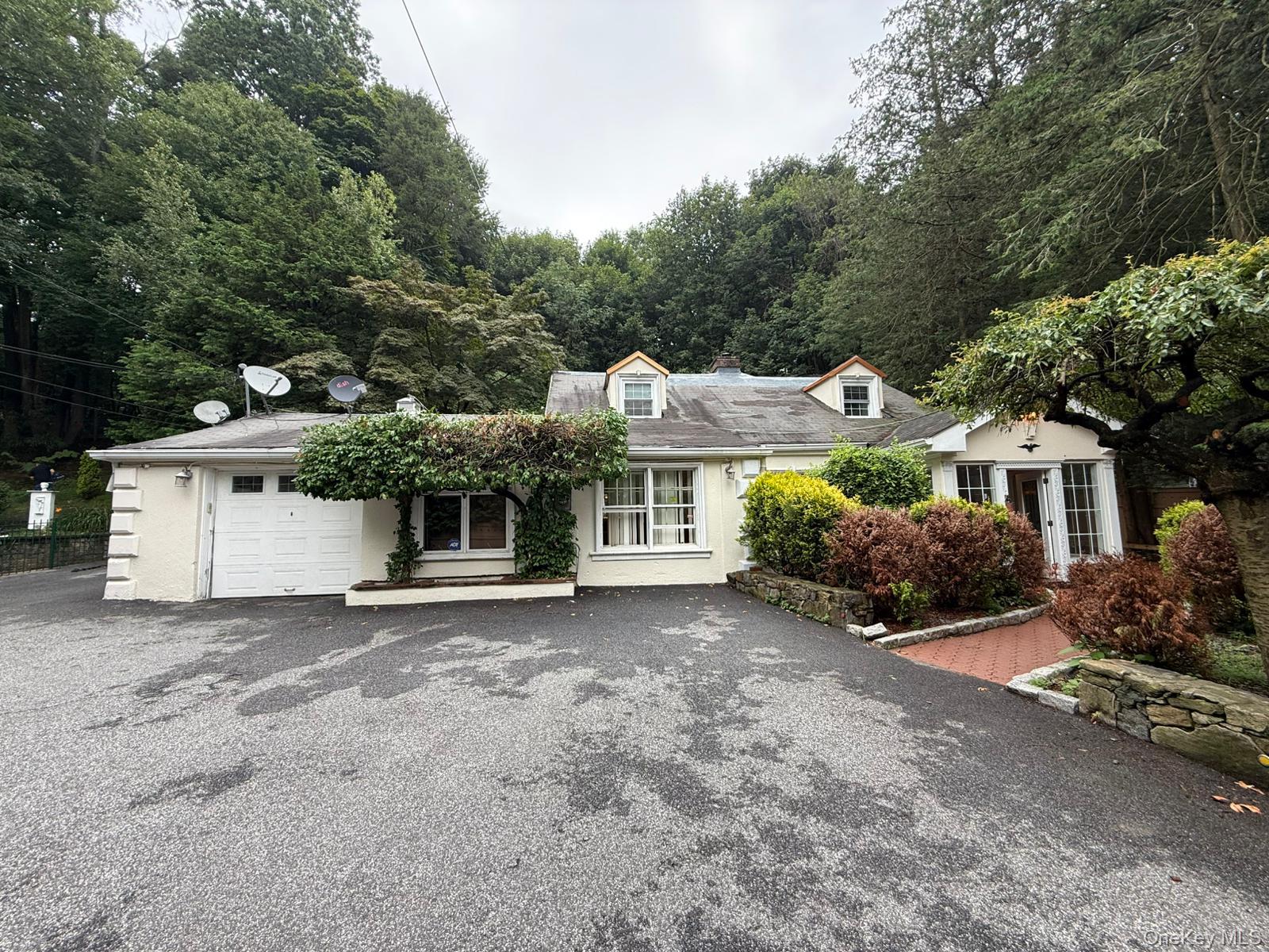 445 Hartsdale Ave is the only property with two huge lots. A private oasis where artful landscaping meets peaceful suburban living—just 20 minutes from Midtown and 1 mile to Metro-North. This fully remodeled 4-bed, 3.5-bath home features wood-beam ceilings, marble baths with skylights, two indoor Jacuzzis, central air, and a new gas boiler. Set on 1.5 fenced acres with three BBQ patios, a meditation patio, and a Bocce court—perfect for entertaining or relaxing under ambient lighting. Includes garage parking, Fios internet, indoor/outdoor laundry, and mechanicals outside the main structure. Enjoy Greenburgh town amenities: pool, tennis, golf, and private parks. A top-rated private school is within short distance. Pool & spa planned for 2026. Live in luxury, surrounded by nature, without sacrificing convenience!