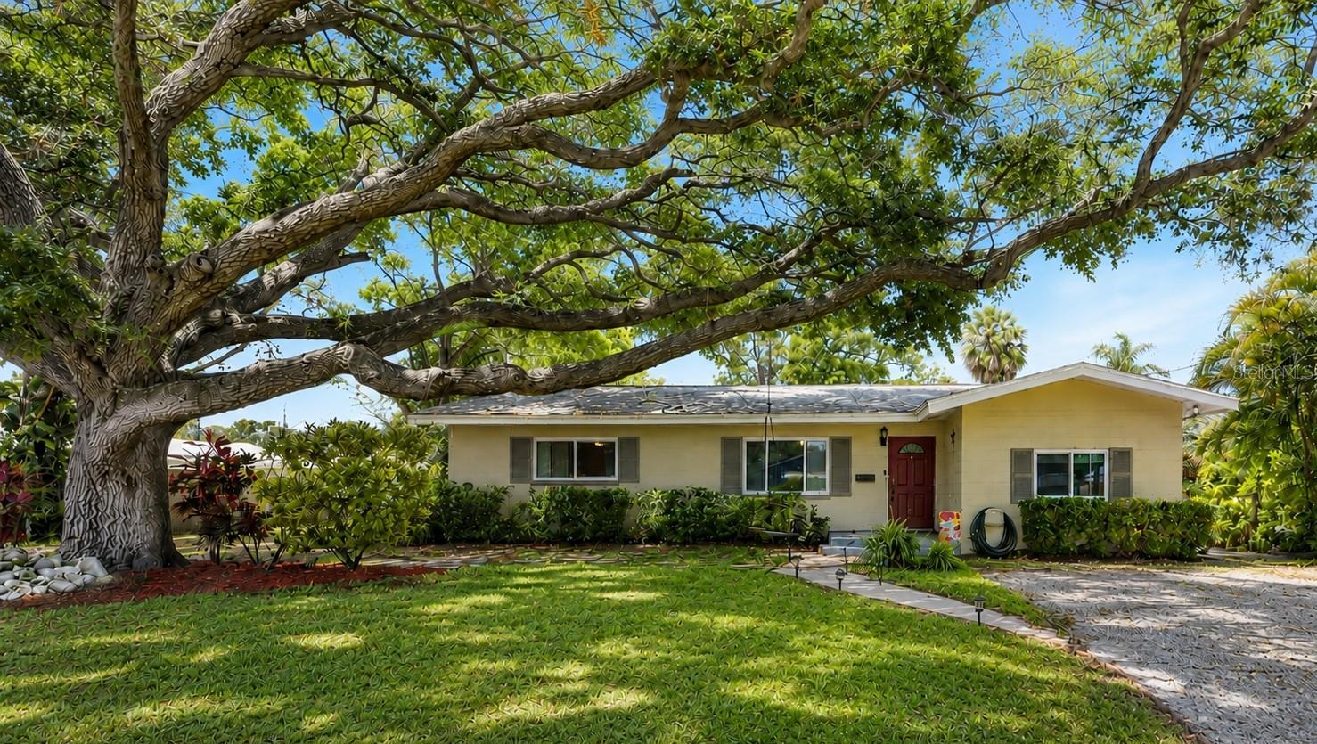 Set on an approximately 1/3 acre lot beneath beautiful mature oak trees, this concrete block 3 bedroom, 2 bathroom home offers the rare combination of space, functionality, character, and an incredibly central Pinellas County location- all while situated in a NON FLOOD insurance required zone. The fully fenced property provides exceptional flexibility with room for boats, RVs, work vehicles, or additional parking, plus a storage shed/utility building and an expansive covered patio that spans the full length of the home, creating the perfect setting for entertaining, relaxing, or future outdoor enhancements. Support beams with ready electrical are already in place for potential overhead outdoor fans or lighting if desired by the next owner. And yes- the chicken coop can stay with an acceptable offer (although the chickens have other plans). Inside, the open-concept split-bedroom floor plan blends comfort with functionality while maintaining warmth and character through charming architectural archways and thoughtfully designed living spaces. The kitchen offers excellent prep and gathering space with a breakfast bar/peninsula, stainless steel LG appliances, updated faucet, disposal (2024), and a designated dining room/flex space ideal for formal dining, a home office setup, or additional entertaining space. The home also features substantial storage throughout, including generous closet space in every bedroom and dual his-and-her closets in two of the three bedrooms. The main bathroom includes a freshly reglazed tub/shower combo with updated fixtures. Major updates provide peace of mind, including a new roof (2024), impact windows and doors installed in 2022/2023 (with transferable warranties on select items), water heater (2025), blown-in insulation for improved energy efficiency, gutters and downspouts added during the roof replacement, and a smart home setup that includes a Nest thermostat, voice-activated smart lighting and fan controls compatible with Alexa/Google systems, plus a smart security package with Ring doorbell cameras and exterior lighting. Levelor blinds are installed throughout the home, and the interior laundry room adds everyday convenience. LG washer and dryer are negotiable with an acceptable offer. Outside, the “blue ribbon” lawn benefits from an automatic sprinkler system utilizing reclaimed water, helping maintain lush landscaping while keeping utility costs lower. Location is another standout feature. Situated in one of the most centralized areas of Pinellas County, the home offers quick access to Interstate 275 for convenient travel to Tampa, Tampa International Airport, Sarasota, Downtown St. Petersburg, and the Gulf beaches. Park Boulevard is just blocks away with nearby restaurants, grocery stores, retail shopping, hospitals, and everyday conveniences all within easy reach. Plus, Downtown St. Pete is only approximately 15-20 minutes away, offering quick access to waterfront parks, dining, nightlife, museums, and entertainment. Seller is motivated and ready to move- offering an exceptional opportunity for buyers seeking space, updates, smart-home convenience, and a highly accessible St. Pete/Tampa Bay lifestyle.