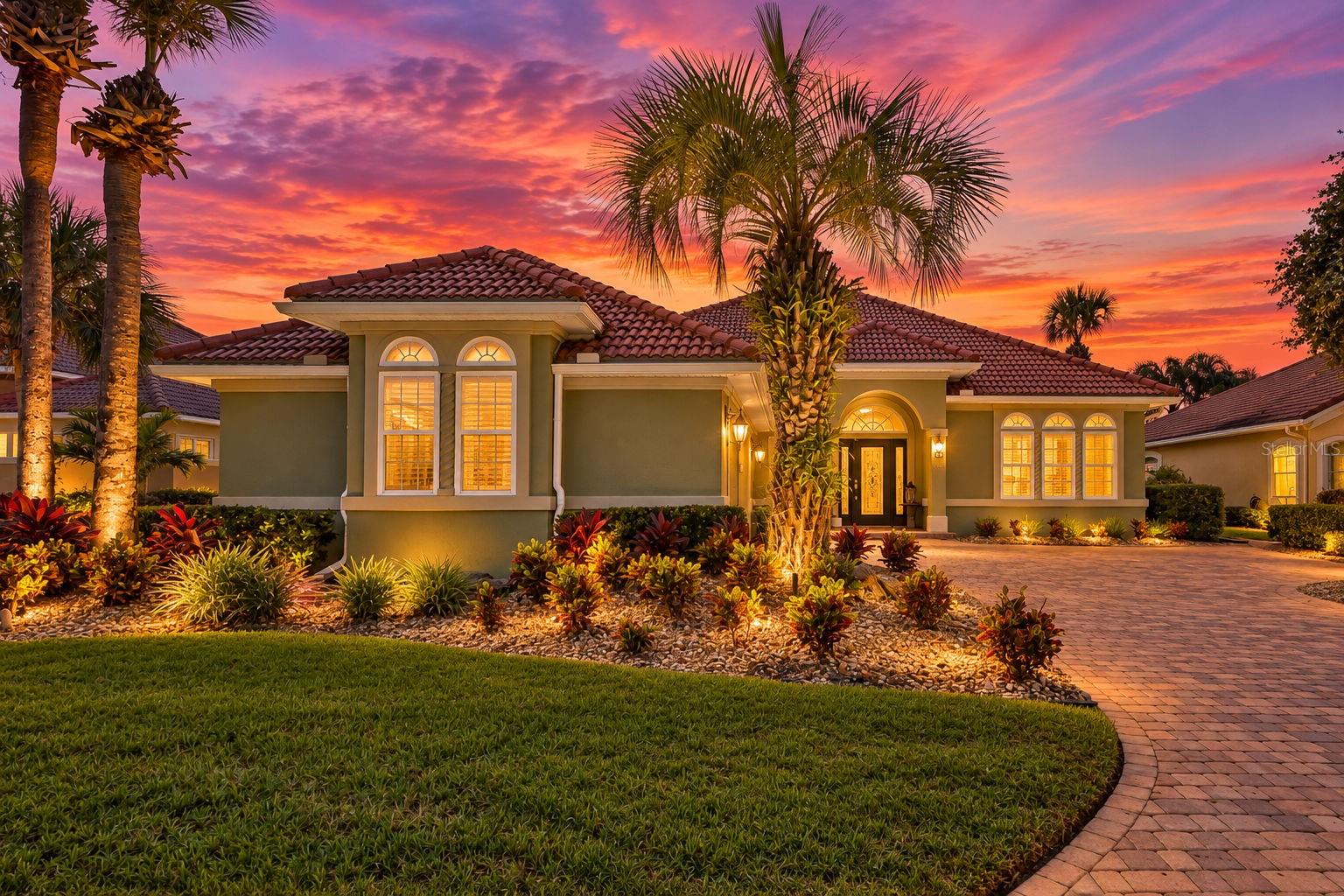 Discover courtyard living with tranquil lake views at 28 Oak View Circle E in Ocean Hammock, a gated coastal community in Palm Coast. With beach access, exceptional golf nearby, and inviting spaces for entertaining and unwinding, this home captures the pleasures of Florida living. The private courtyard centers around a heated salt spool—a combination pool and spa—accented by a beautiful rock waterfall. Enjoy a refreshing afternoon dip or a soothing warm-water soak surrounded by the sound of cascading water. An outdoor kitchen and gathering space set the scene for memorable evenings. Picture your closest friends, dinner on the grill, and the big game playing as everyone relaxes together in your own courtyard oasis. Inside, tile and hardwood flooring flow throughout, complemented by thoughtfully planned custom lighting that brings warmth and character to each space. The kitchen features a prep island, breakfast bar, and stainless steel appliances, making meal preparation and conversation equally inviting. Four generously sized bedrooms offer comfortable retreats, with select bedrooms opening to patio spaces. The front bedroom enjoys a lovely view of the home’s approach and driveway. Beautiful lake views provide a peaceful backdrop, extending the living experience onto the expansive covered, screened patio spanning the rear of the home where you can enjoy listening to the waves of the nearby ocean. From morning coffee beside the water to quiet evenings outdoors, this lakeside setting invites you to slow down and savor your surroundings. Beyond the home, enjoy Ocean Hammock’s beach and golf lifestyle, with optional membership opportunities at The Club at Hammock Beach or Hammock Dunes Club for additional recreation, dining, and social activities. Memberships are separate and subject to availability, approval, fees, and club terms. A private courtyard, heated spool, outdoor kitchen, lake views, ocean lullabies and generous outdoor living spaces come together in a home designed for both connection and quiet escape.