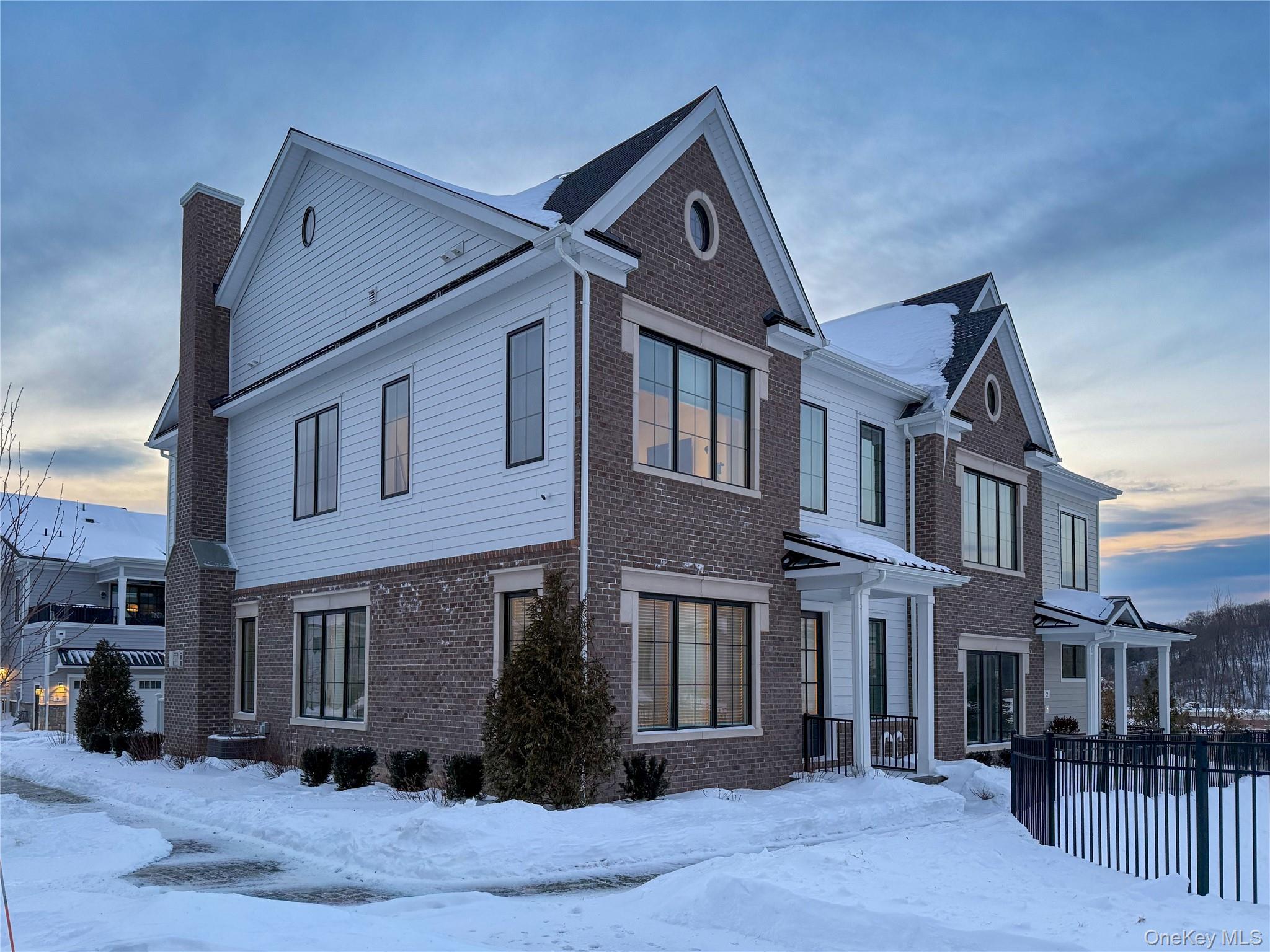 A rare opportunity to own one of the few true 3-bedroom townhomes in Chappaqua Crossing Carriages, a sold-out luxury community within the highly sought-after Chappaqua School District. With all three bedrooms ideally situated on the second floor — a layout rarely available here — this exceptional end unit combines smart design with high-end finishes and extensive upgrades throughout. The main level offers a welcoming entry foyer with a versatile formal living room and powder room near the entrance, ideal as a sitting room, second office, or flex space. The heart of the home is the chef’s kitchen with custom cabinetry, premium appliances, waterfall quartz island, and pantry, open to the dining area and family room with gas fireplace. A two-car garage connects to a custom mudroom with built-in cubbies, bench, and closet. Upstairs includes three bedrooms, a dedicated home office, and a second family room with wet bar and wine refrigerator with large sliding glass doors to a large covered private terrace. The primary suite features a modern tray ceiling, a walk-in closet and spa-like bathroom with a double-sink vanity, oversized shower, and private toilet room. A hall bath with double sinks and a second-floor laundry room complete the level. Additional highlights include 12-foot ceilings, oversized windows, quartz countertops throughout, abundant storage, whole-house air filtration, and a full unfinished basement with plumbing and egress for future expansion. Community amenities include a clubhouse with gym, entertaining spaces, outdoor pool, shuttle to the Chappaqua train station, and walkable access to shopping, dining, Whole Foods and Life Time Fitness.
