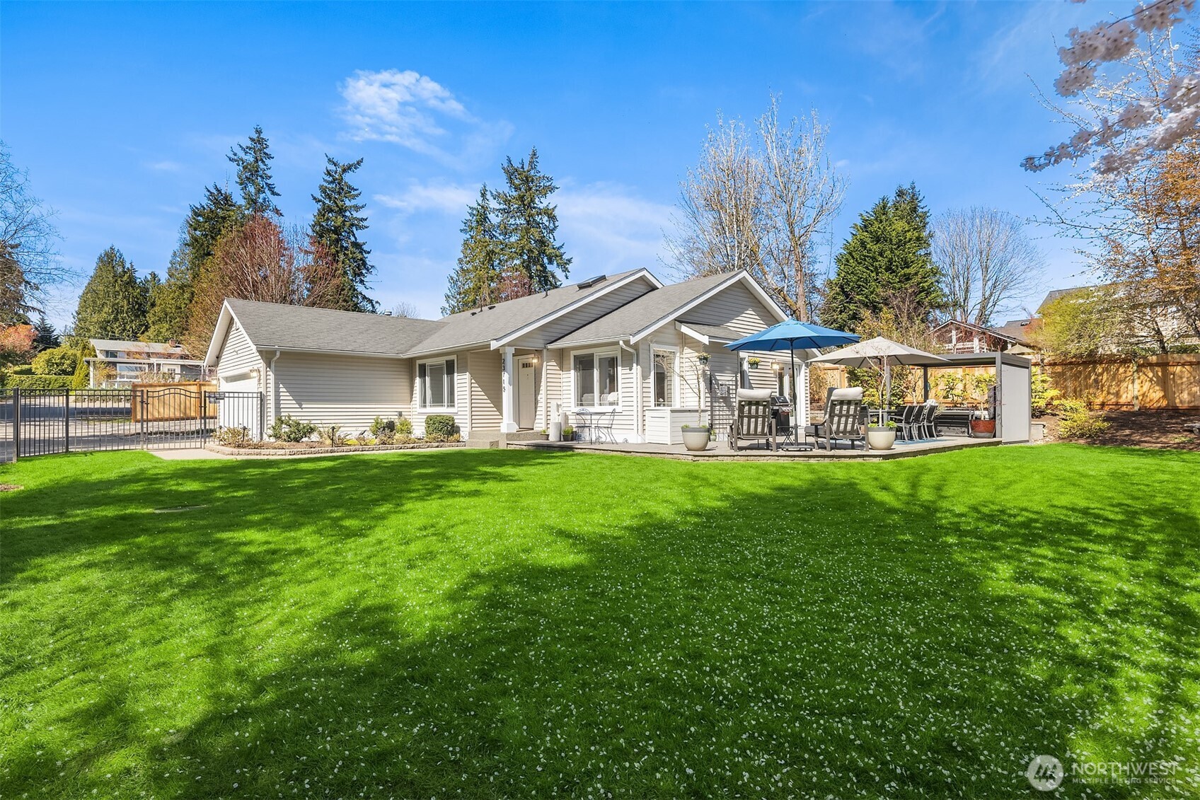 A beautifully designed outdoor retreat takes center stage in this sunny, light-filled rambler set at the end of a quiet private road in Brier. The fully fenced, south- and east-facing backyard is a true sanctuary—lush, meticulously maintained, and thoughtfully designed with a wraparound patio, hot tub under a gazebo, garden beds, and plenty of space to relax, entertain, and enjoy peaceful outdoor living. Inside, the open floor plan feels bright and inviting, with cathedral ceilings, skylights, and abundant natural light throughout. The updated kitchen with granite counters and a large eating bar opens seamlessly to the dining and living areas, anchored by a cozy gas fireplace and direct access to the backyard—creating effortless indoor-outdoor flow. Three spacious bedrooms include a primary suite with en-suite bath, offering comfort and privacy. RV parking, a spacious two-car garage, and a side yard with a large shed provide excellent storage and flexibility. An efficient heat pump offers year-round heating and cooling. Located in the Northshore School District with easy access to the light rail, highways, parks, and shopping. The good life starts here!