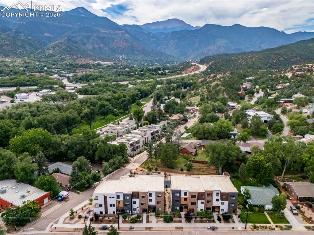 Exceptional 3-story builder’s end-unit townhouse with a private in-unit elevator serving all levels, completed in 2025 and never lived in. This premier residence features the finest upgrades in the community and an ideal end-unit location offering abundant natural light, privacy, and stunning mountain views—a rare opportunity to own the builder’s showcase residence with design-forward finishes and elevator access seldom found in Manitou Springs. The open-concept great room showcases wormy maple hardwood floors, custom metal accents, and recessed LED lighting.The gourmet kitchen impresses with an oversized waterfall island, 8-burner FORNO double-oven range, KitchenAid stainless appliances, walk-in pantry, and sleek modern finishes. The living area features a gas fireplace, built-in shelving, oversized windows framing Pikes Peak views, and direct access to one of four private decks.The primary suite is a private retreat with gas fireplace, dual walk-in closets, private deck, and a spa-inspired bath with steam shower, heated floors, and smart backlit mirror. Additional bedrooms offer en-suite baths with heated floors and a jetted tub. Two-car garage, four private decks plus side patio. Ideally located minutes from downtown Manitou Springs, Old Colorado City, Garden of the Gods, and Red Rock Canyon.